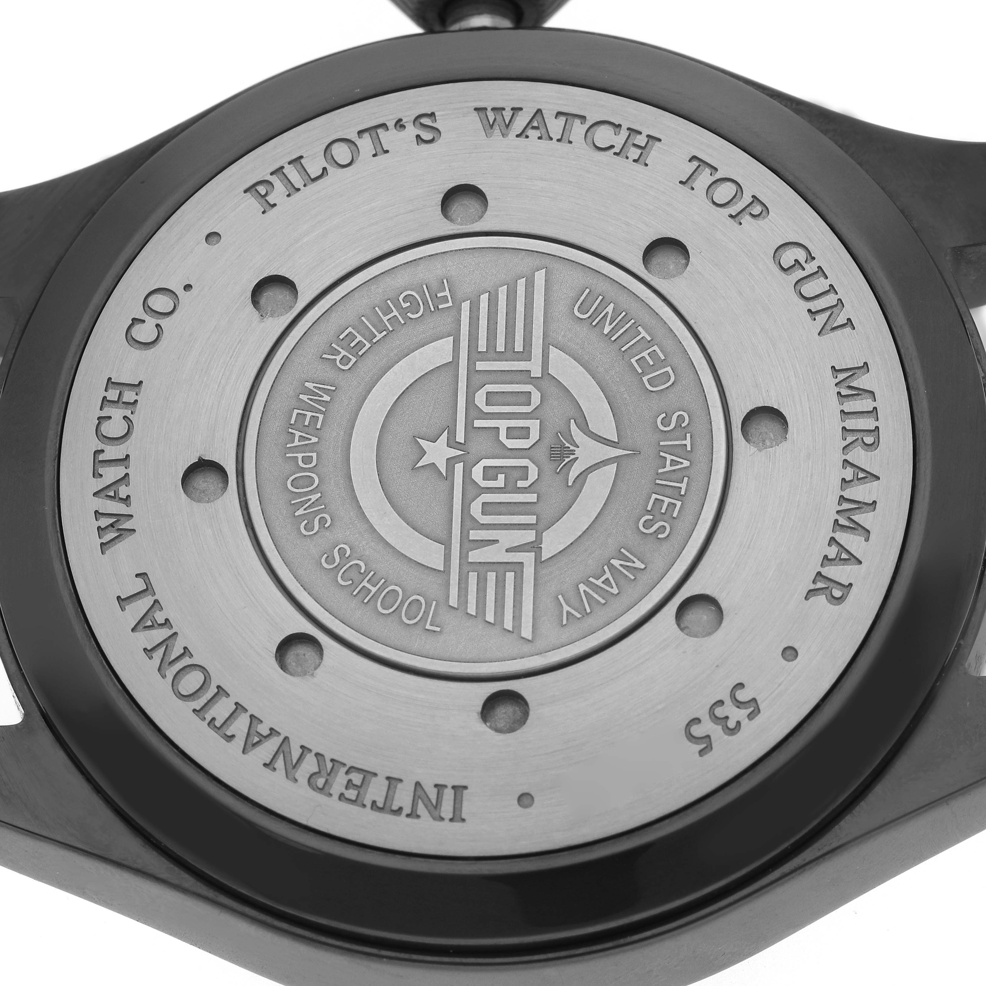 The image shows the case back of an IWC Pilot IW501902 Men's Ceramic Grey Dial’s Watch, featuring "TOP GUN" engravings.