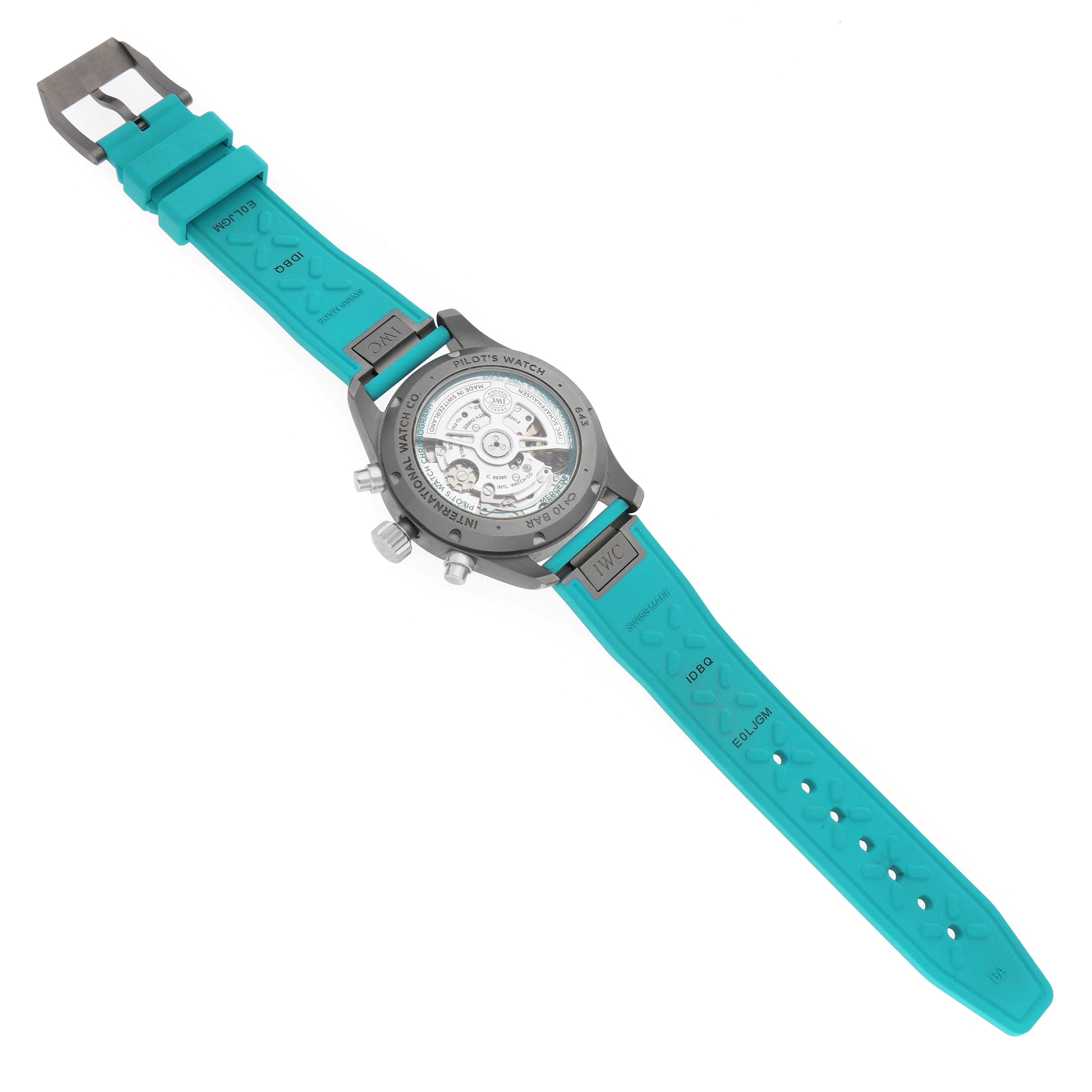 The image shows the back of an IWC Pilot IW388108 Men's Titanium Black Dial watch with a visible movement and turquoise strap.