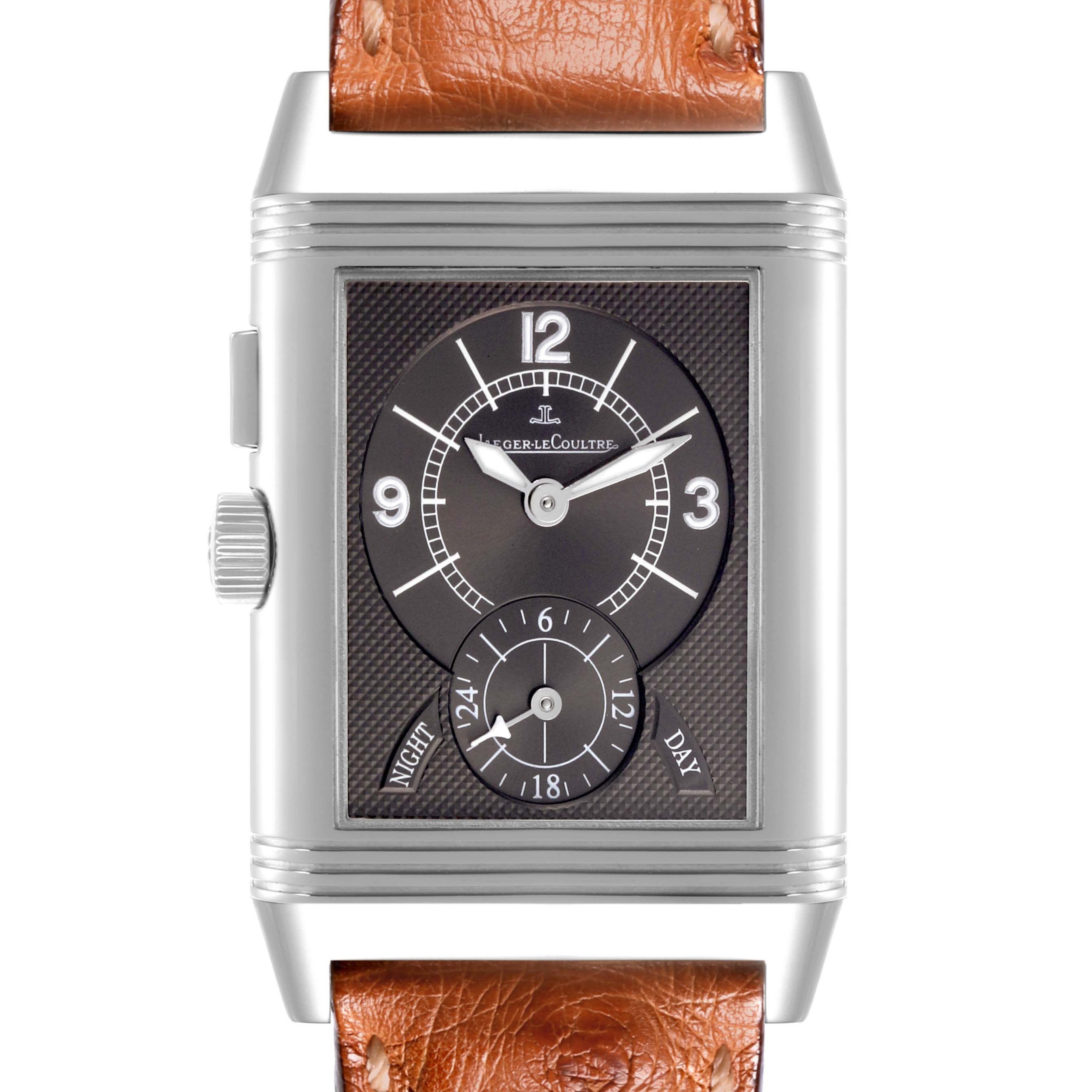 The Jaeger-LeCoultre Reverso watch is shown from the front, highlighting its rectangular dial and side crown.