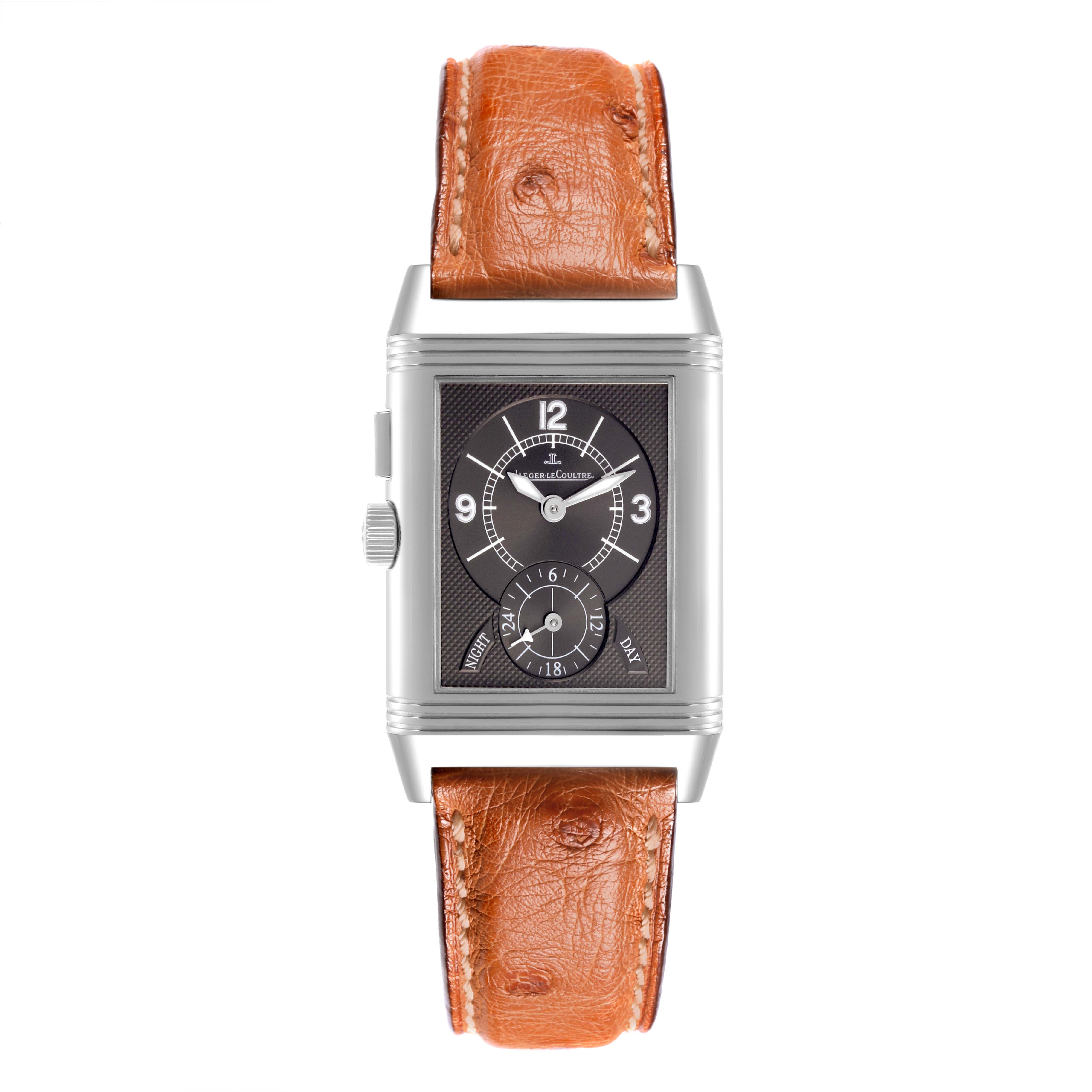 The Jaeger-LeCoultre Reverso watch is shown from a front angle, highlighting its face, case, and brown leather strap.