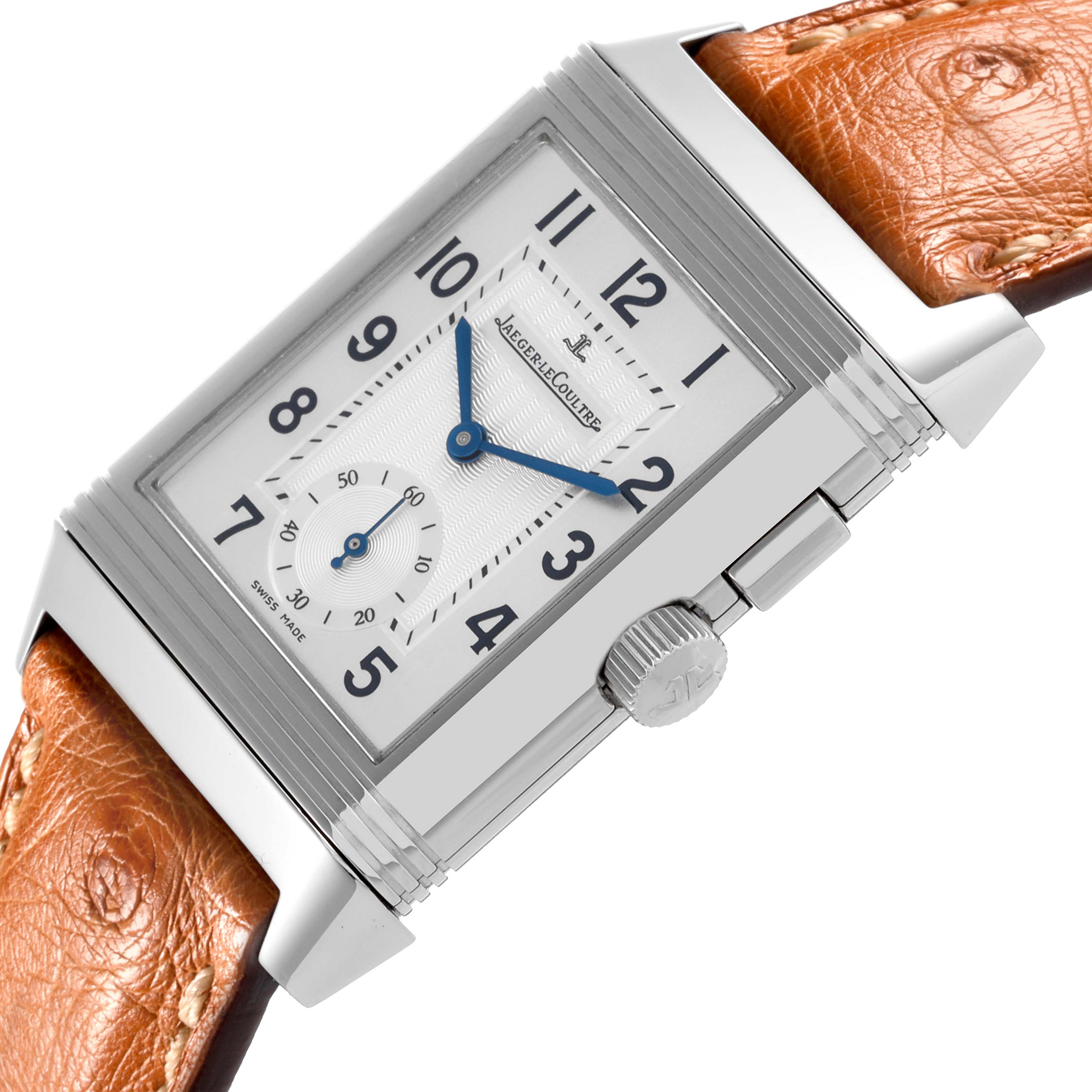 The Jaeger-LeCoultre Reverso watch is shown in a close-up angle, highlighting the dial, crown, and leather strap.