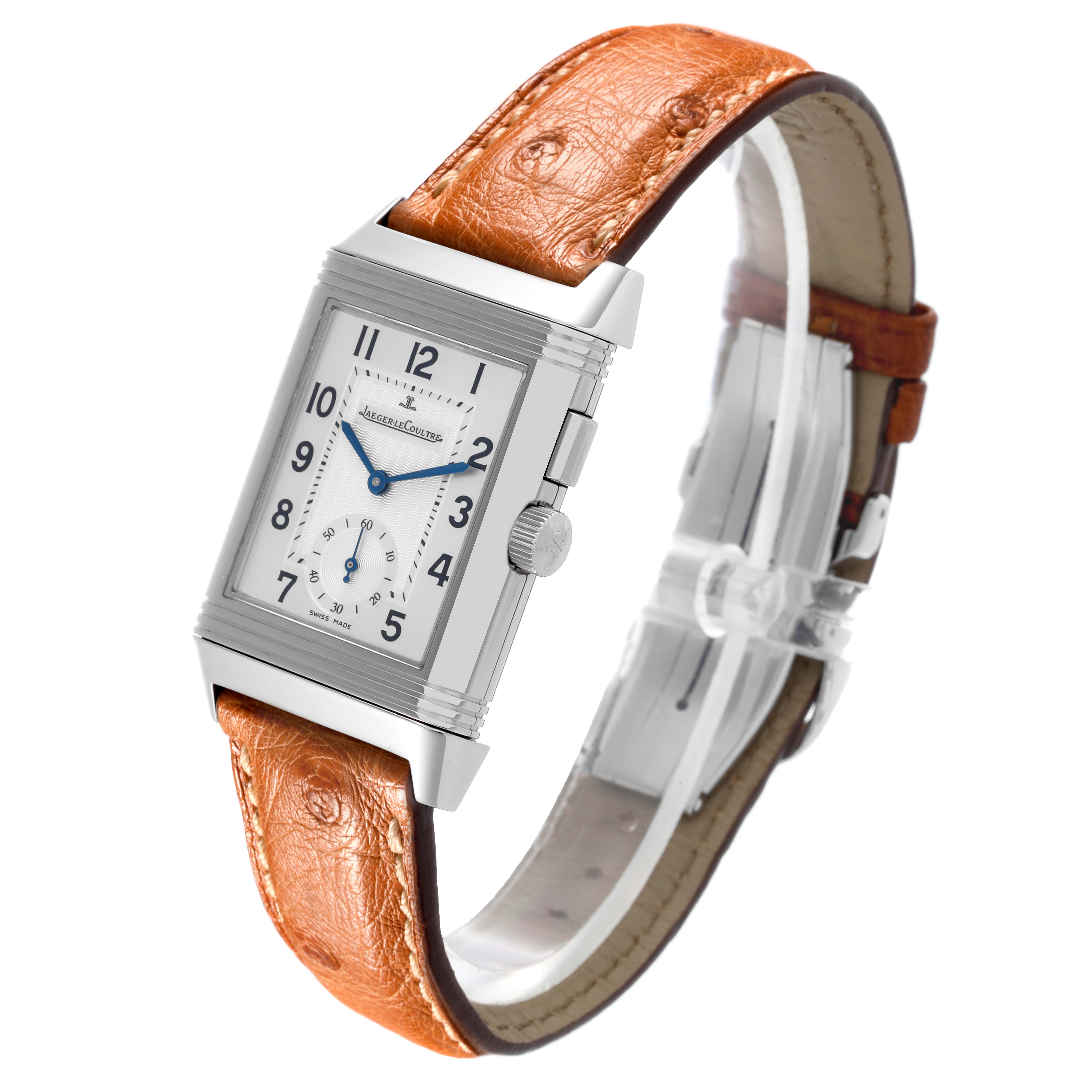 The Jaeger-LeCoultre Reverso watch is shown at a three-quarter angle, highlighting the front, side, and leather strap.