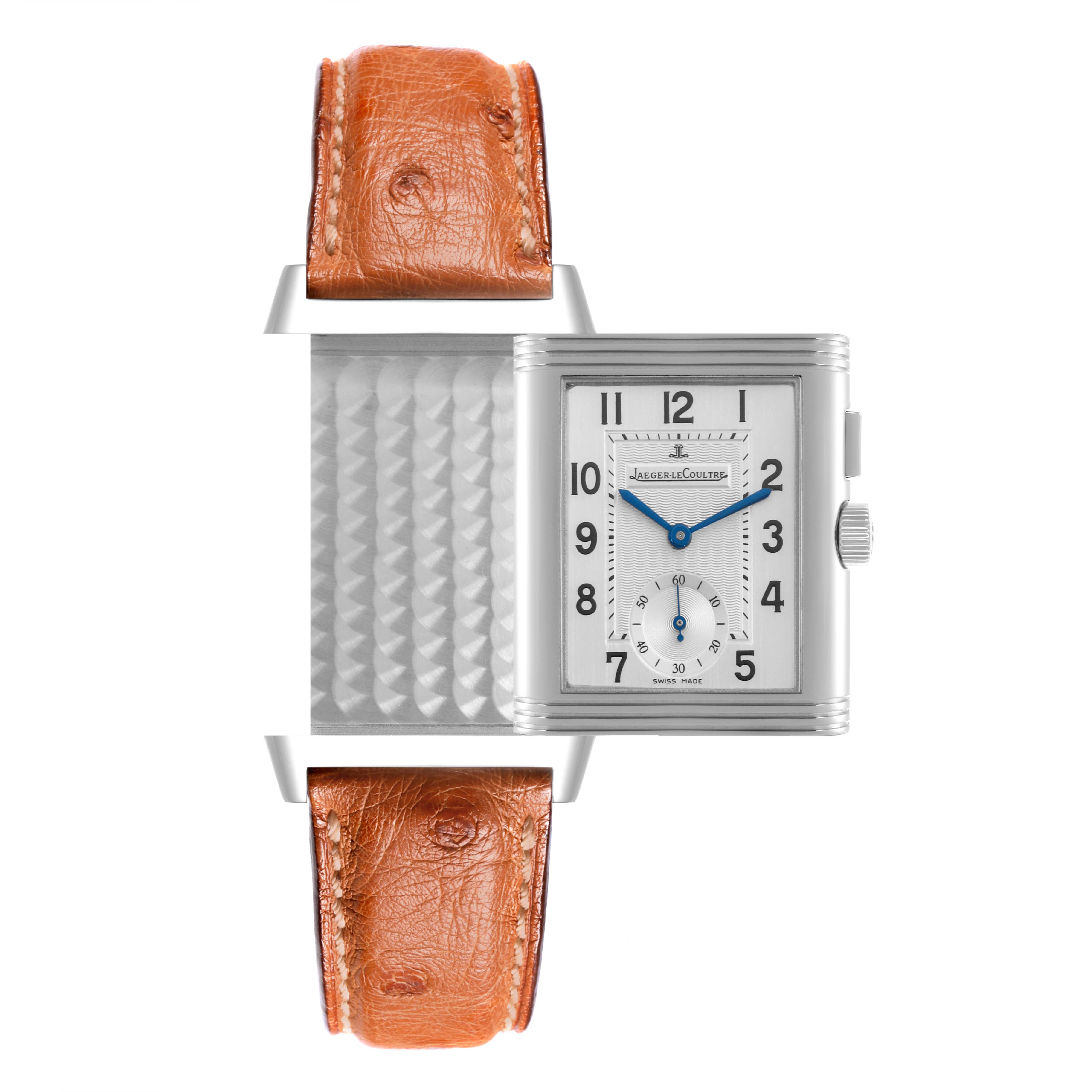 The Jaeger-LeCoultre Reverso watch is shown from the front, highlighting its reversible case and brown leather strap.