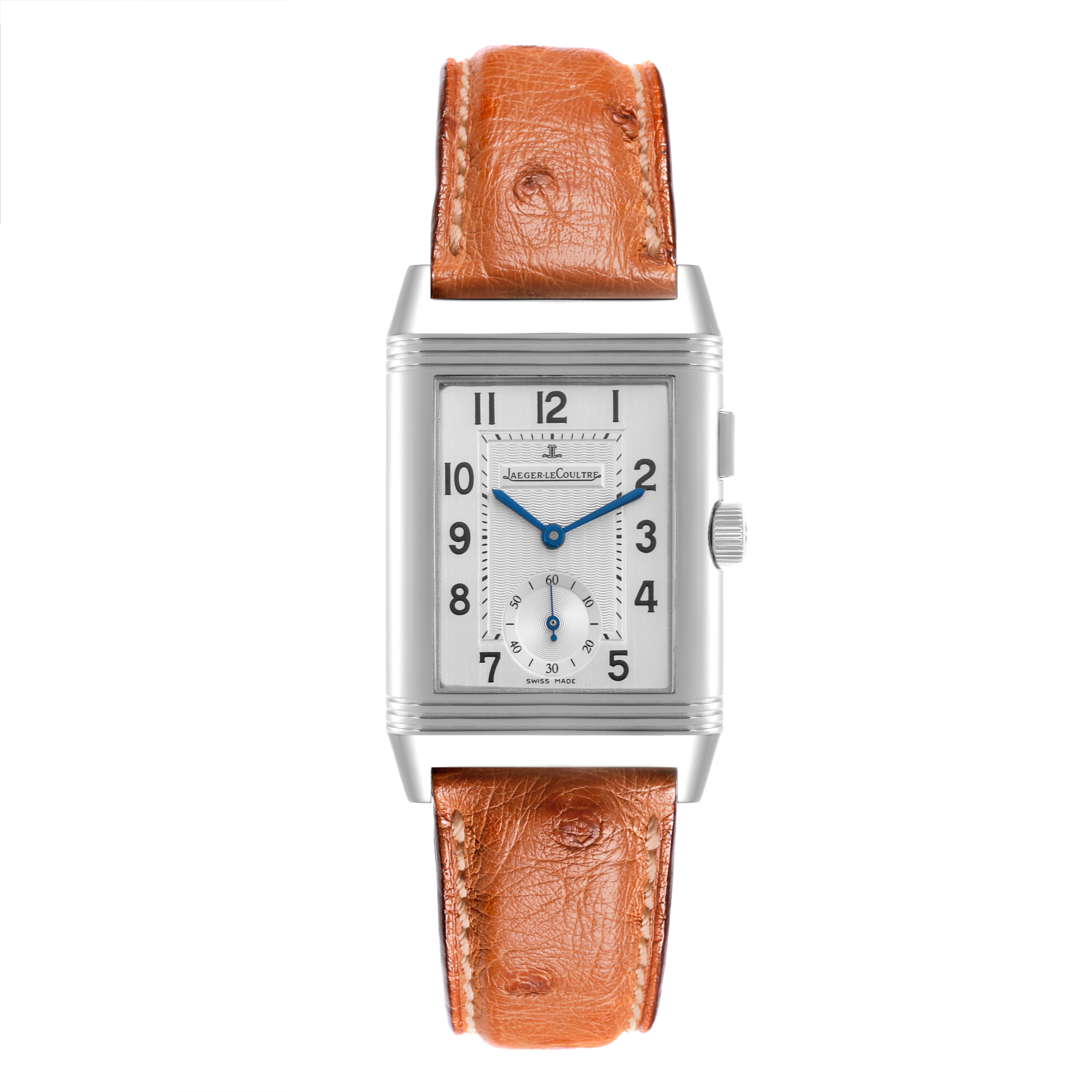 The Jaeger-LeCoultre Reverso watch is shown from the front, displaying its rectangular face, leather strap, and side crown.