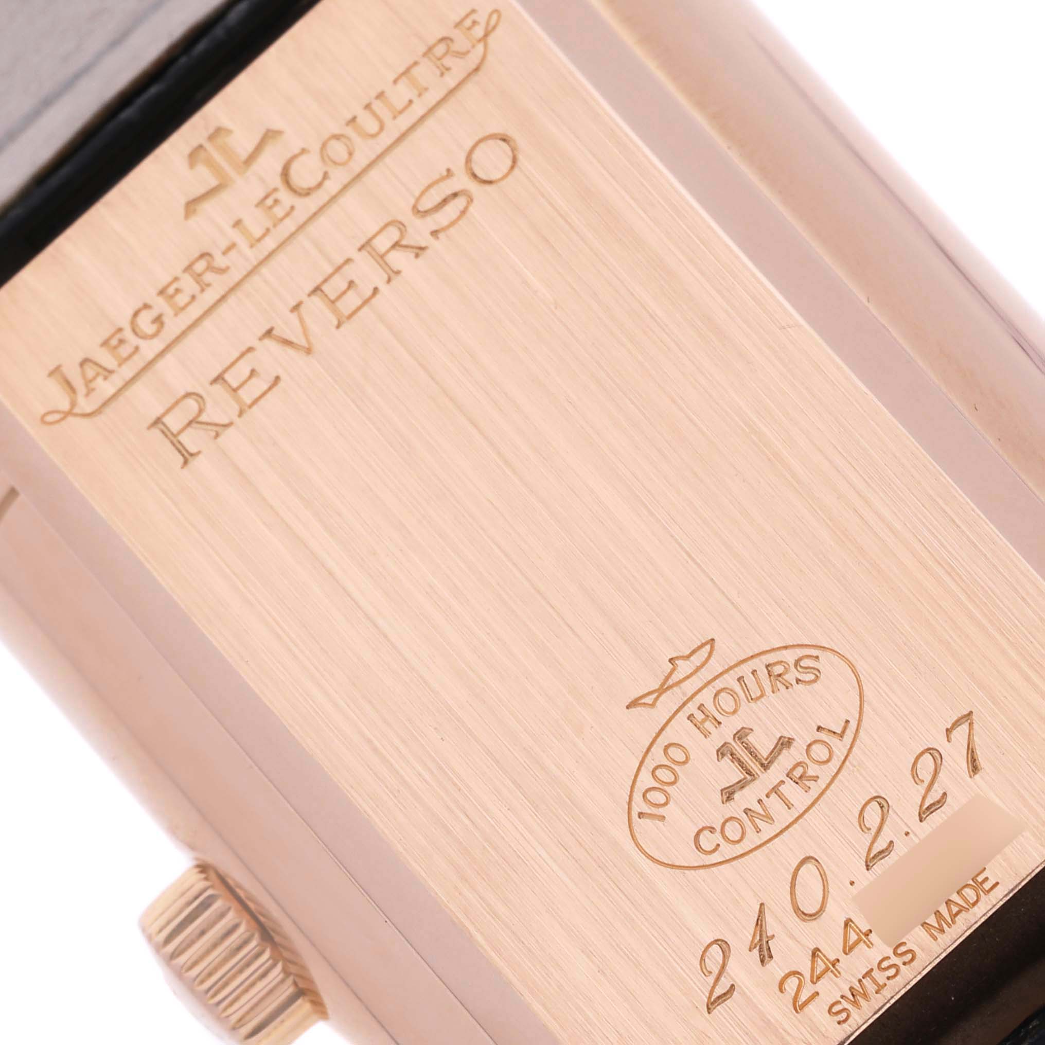 The image shows the back of a Jaeger-LeCoultre Reverso watch, highlighting its engraved details.
