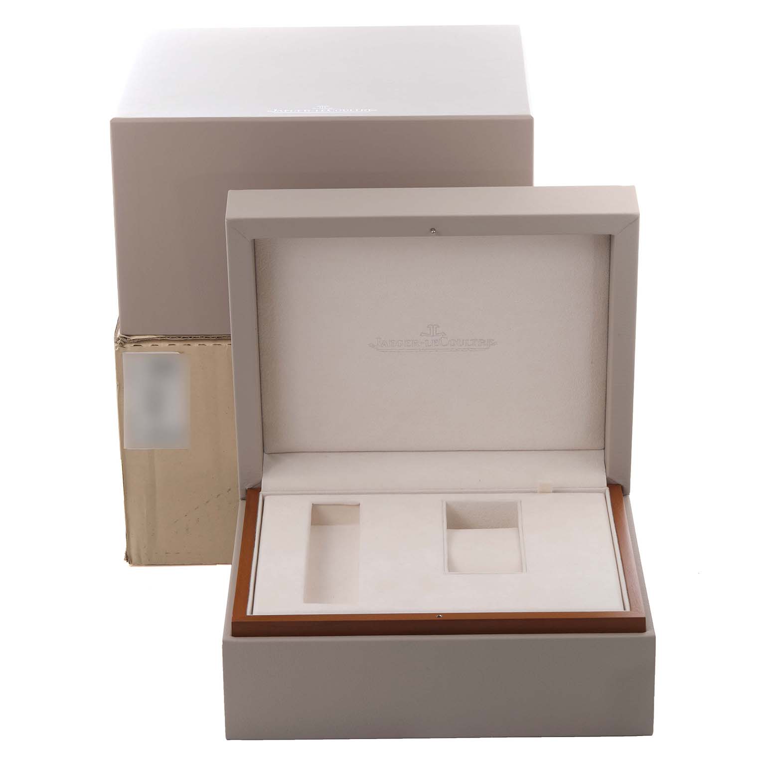 The image shows an open Jaeger LeCoultre Reverso Q3042420 Men's Rose Gold Silver Dial Q3042420 Men's Rose Gold Silver Dial watch box, revealing compartments for accessories.