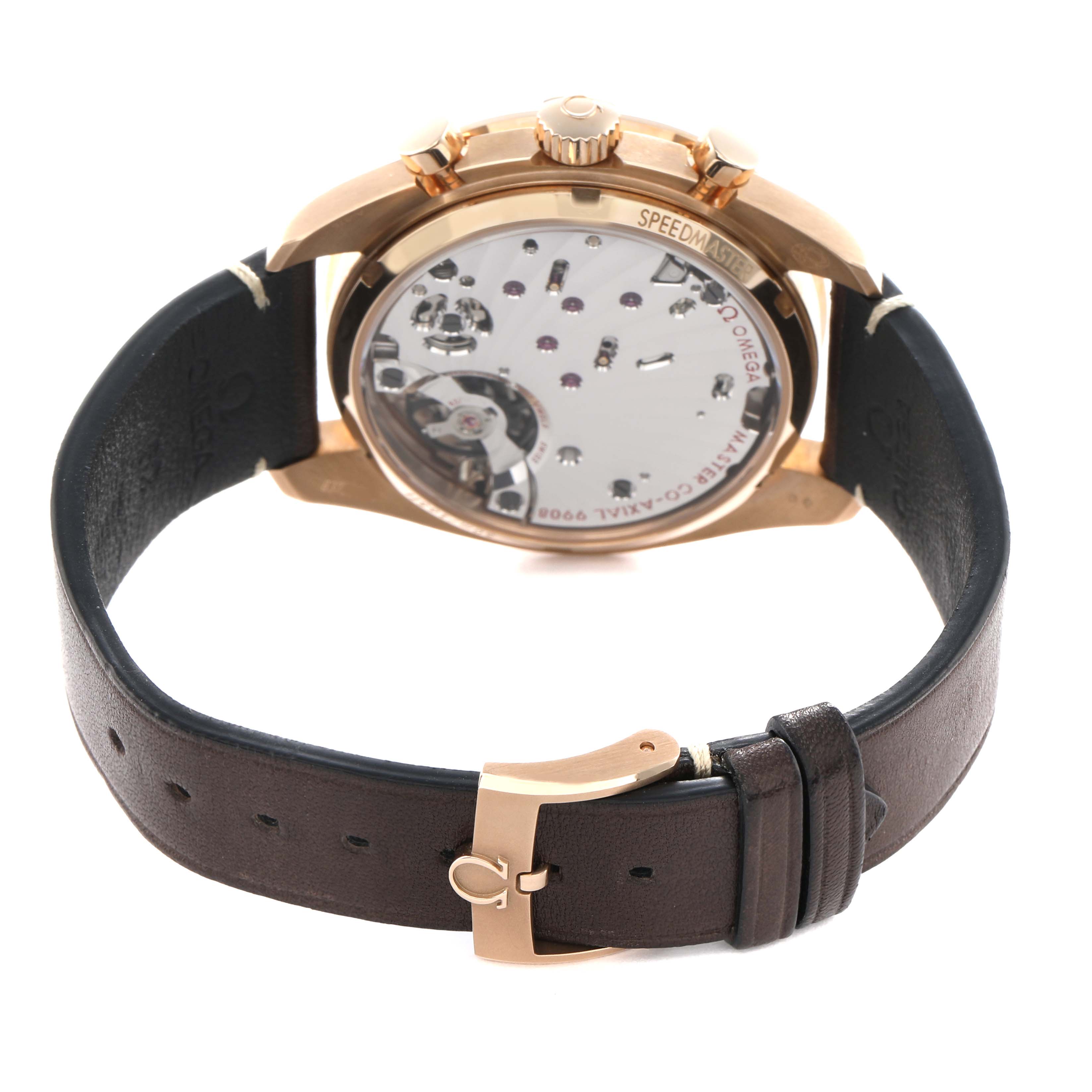 The Omega Speedmaster 329.92.43.51.10.001 Men's Rose Gold Brown Dial is shown from the back, highlighting its movement and brown leather strap with a clasp.