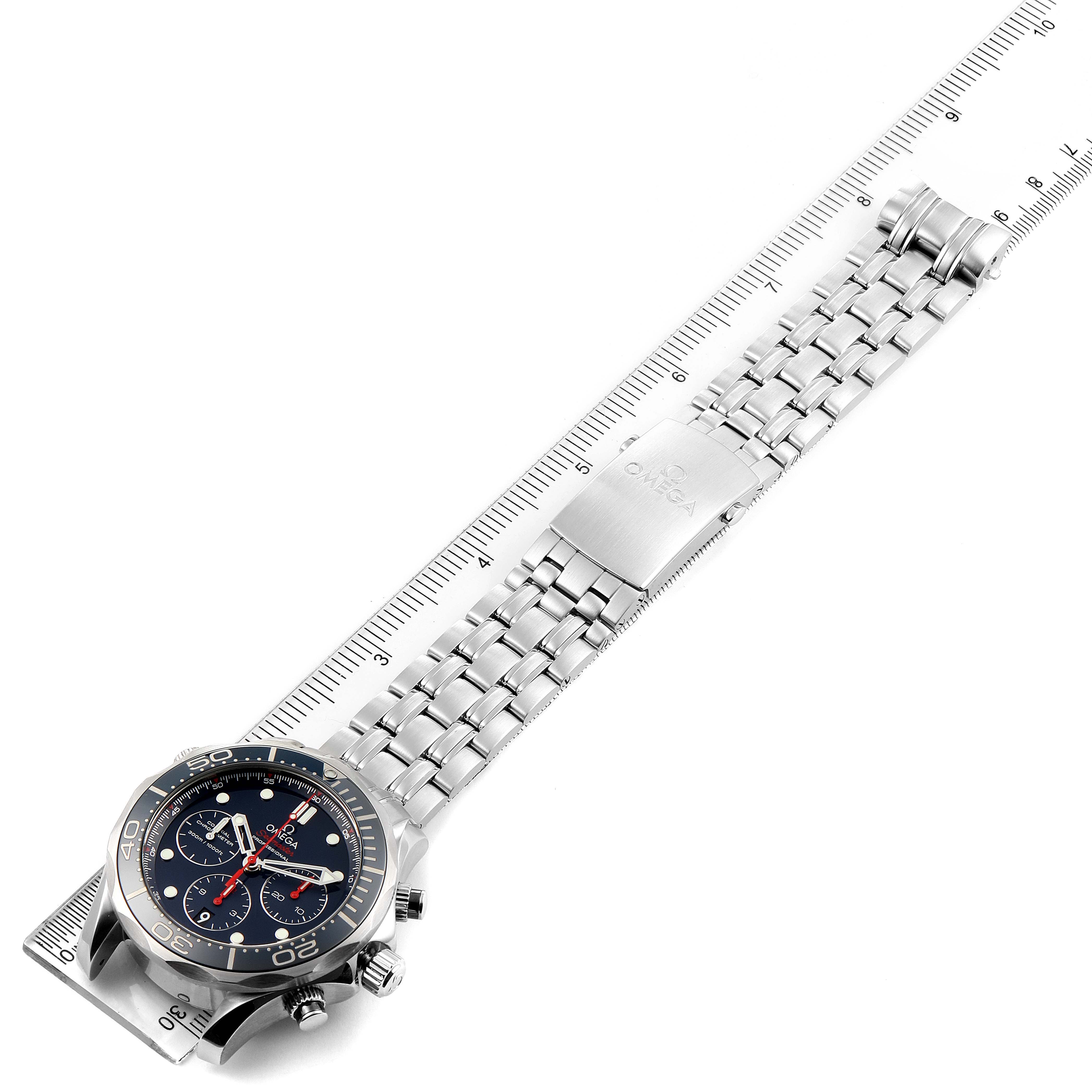 The image shows an Omega Seamaster 212.30.44.50.03.001 Men
s Stainless Steel Blue Dial 212.30.44.50.03.001 Men
s Stainless Steel Blue Dial watch, featuring the dial, bezel, case, metal link bracelet, and clasp, all laid alongside a ruler.