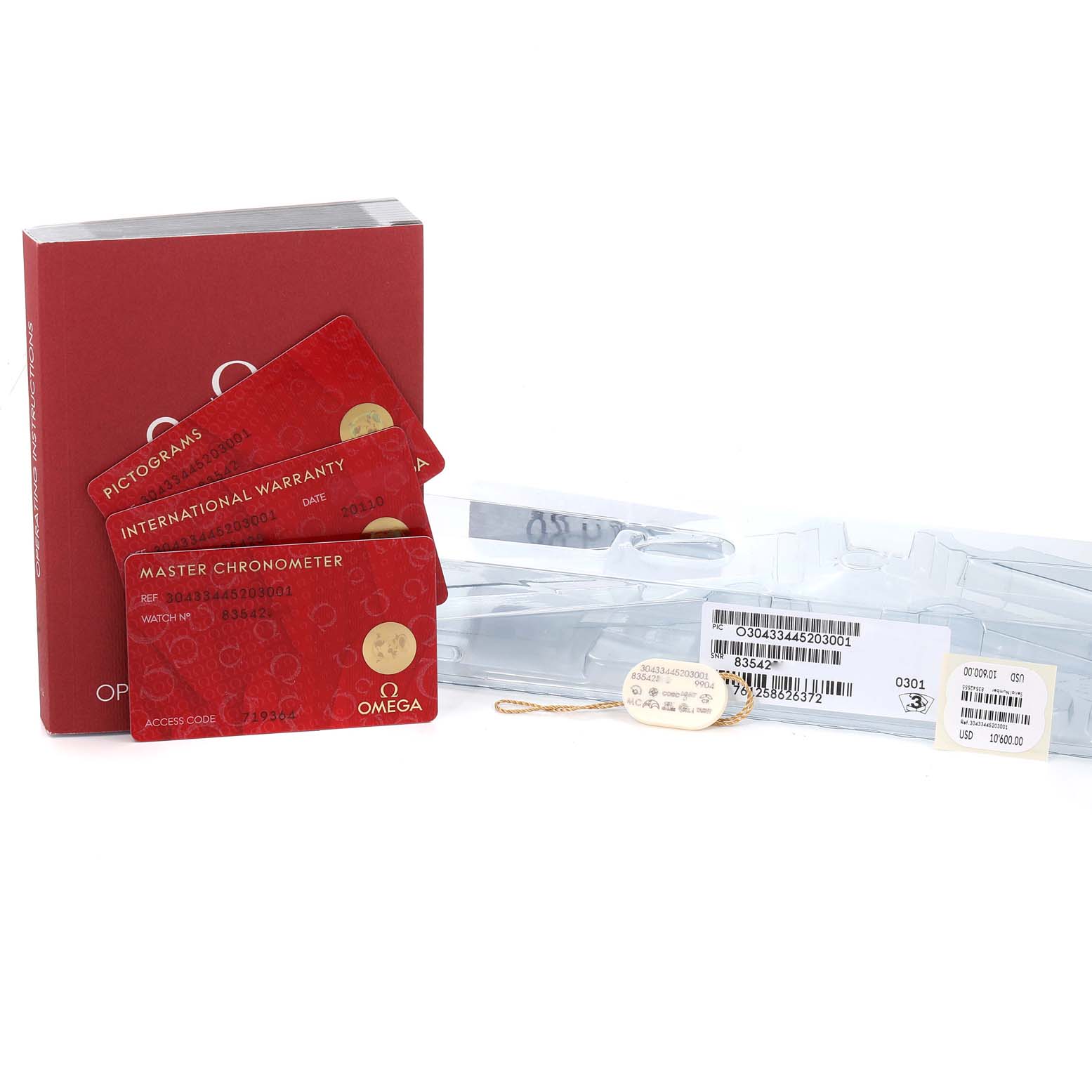 The image shows warranty cards and tags for an Omega Speedmaster 304.33.44.52.03.001 Men's Stainless Steel Blue Dial 304.33.44.52.03.001 Men's Stainless Steel Blue Dial, along with manuals and packaging materials.