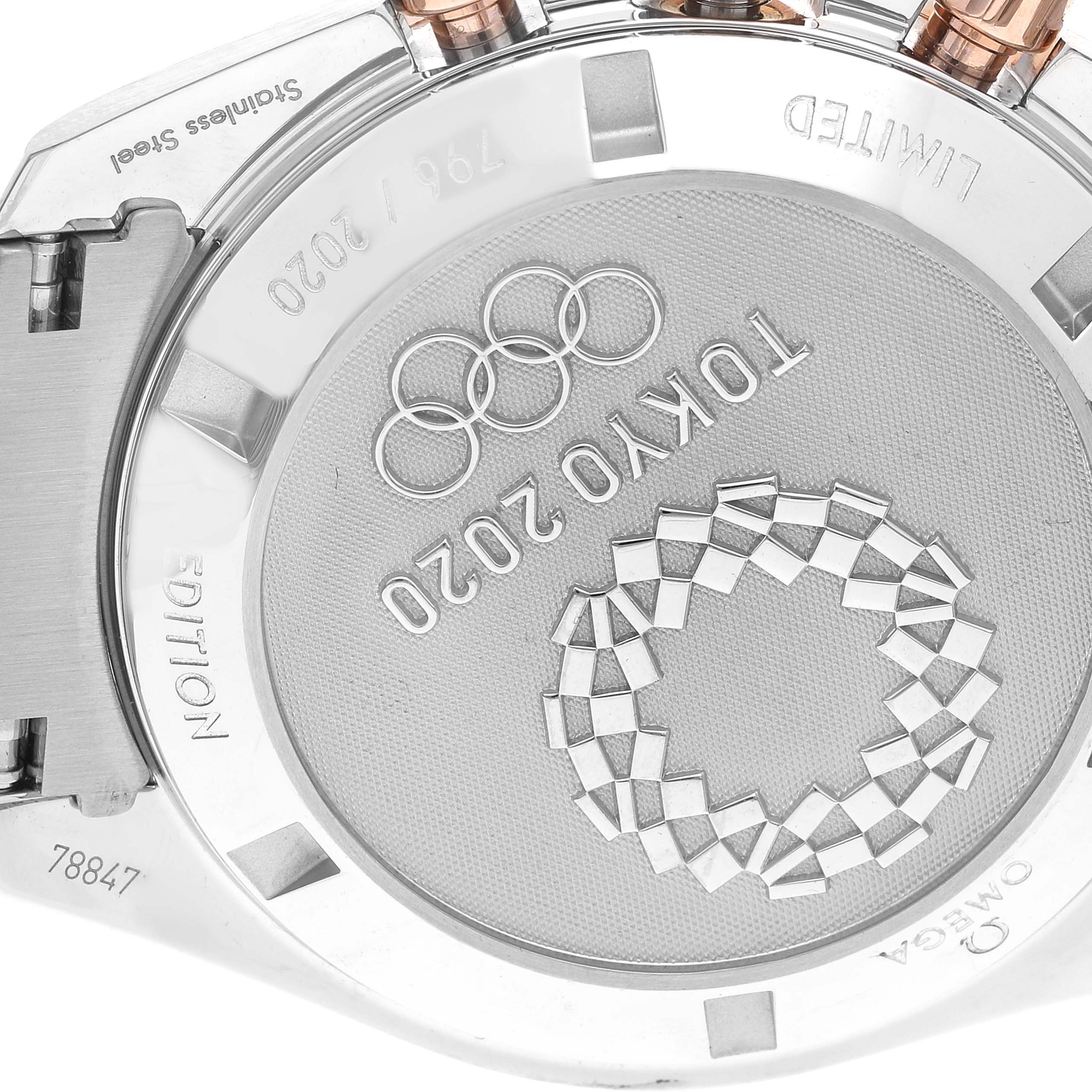 The image shows the Omega Speedmaster 522.20.42.30.06.001 Men's Steel and Gold (two tone) Silver Dial 522.20.42.30.06.001 Men's Steel and Gold (two tone) Silver Dial's case back with an engraved design for the Tokyo 2020 Olympics.