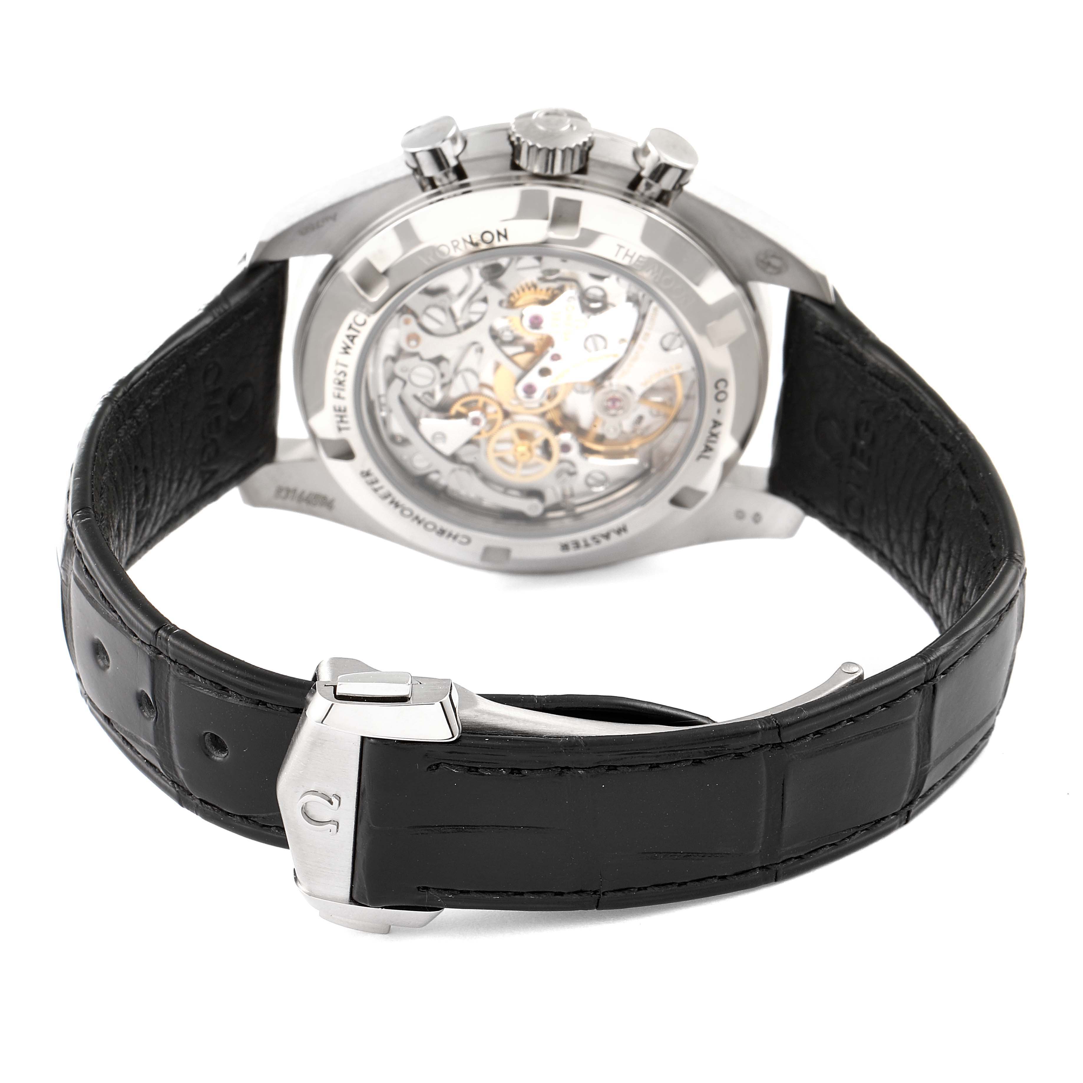 The image shows the back of an Omega Speedmaster 310.63.42.50.02.001 Men
s White Gold Silver Dial 310.63.42.50.02.001 Men
s White Gold Silver Dial watch, highlighting the movement through a transparent caseback and a leather strap.