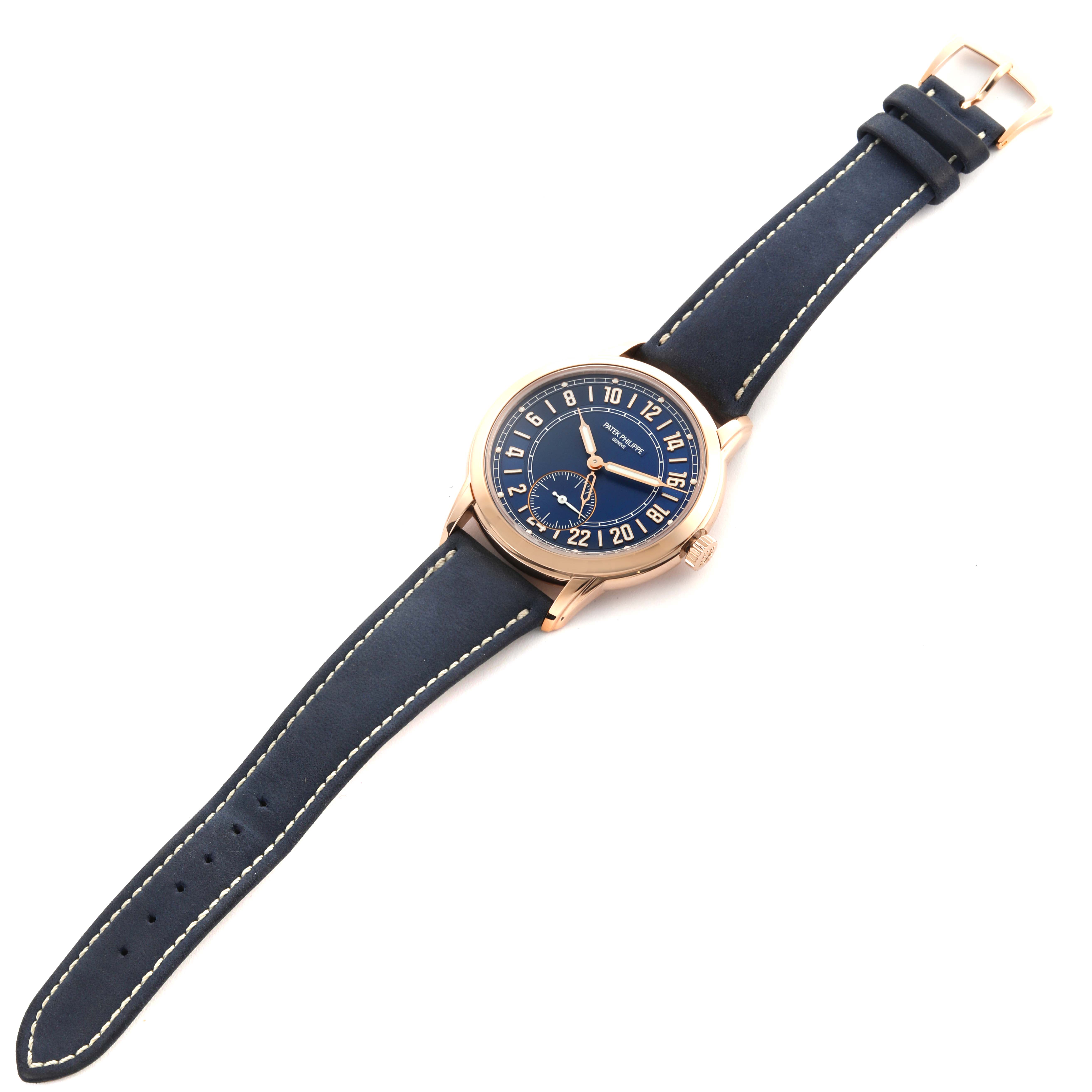 The Patek Philippe Calatrava 5224R-001 Men's Rose Gold Blue Dial 5224R-001 Men's Rose Gold Blue Dial watch is shown from a top-down angle, displaying the full face, case, and leather strap.