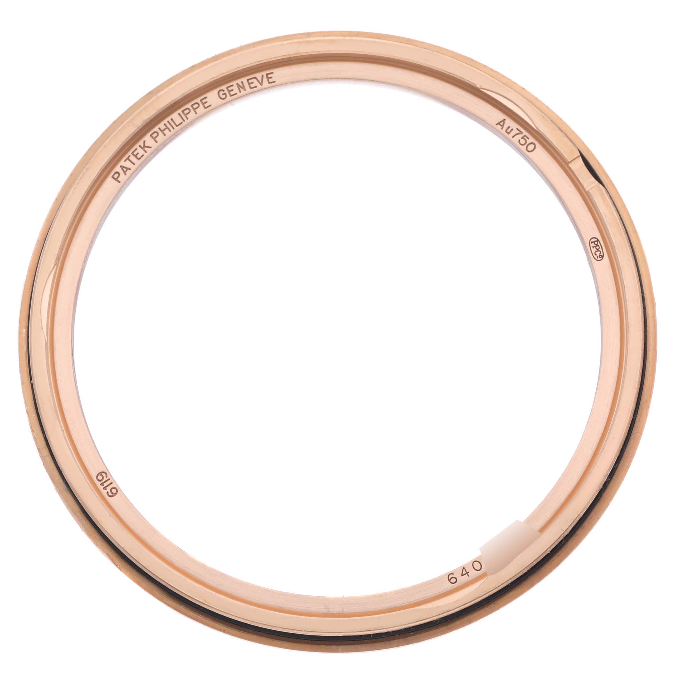 The image shows a close-up of the Patek Philippe Calatrava 6119R-001 Men's Rose Gold Silver Dial 6119R-001 Men's Rose Gold Silver Dial model's rose gold bezel, viewed from an angle that highlights the markings and metal texture.