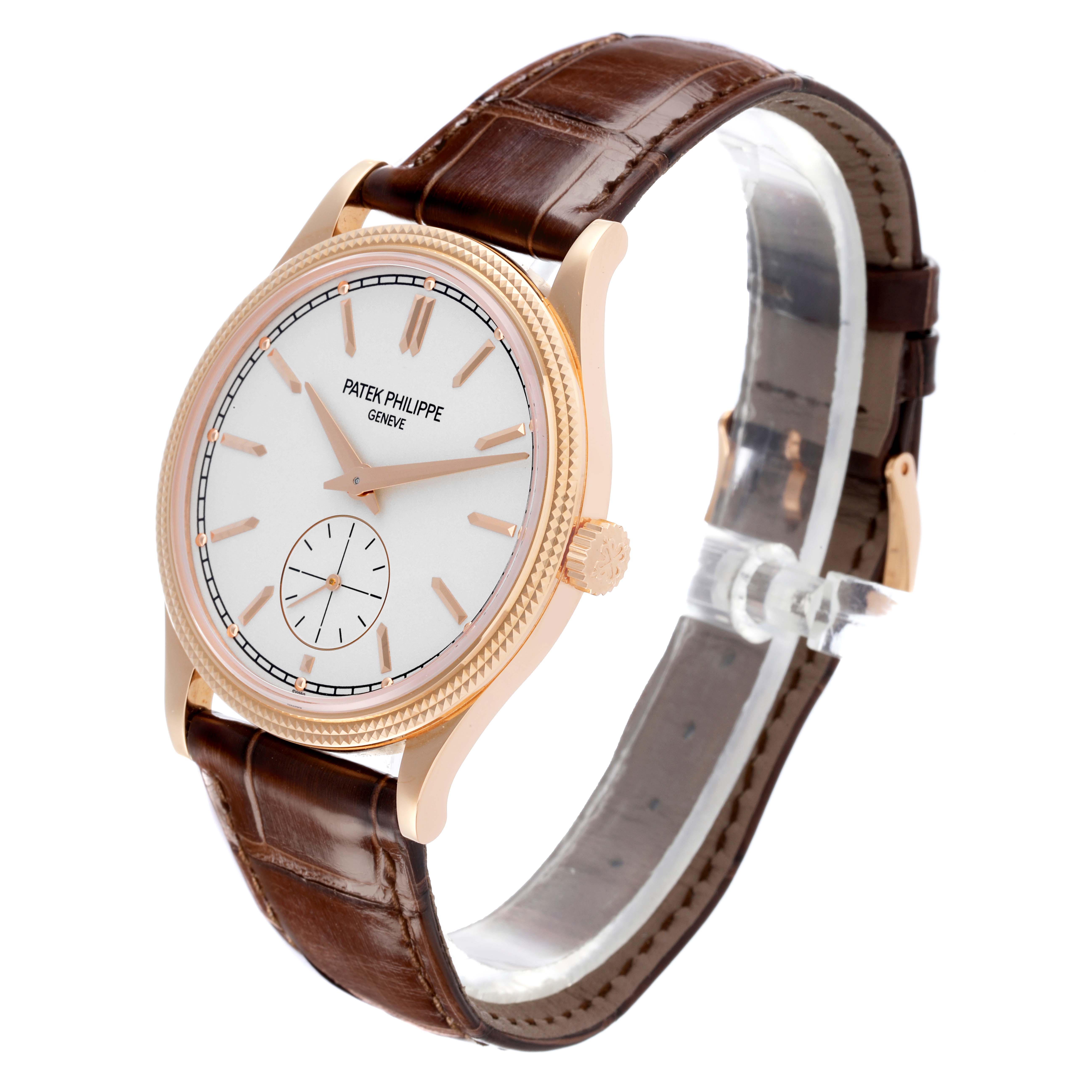 The Patek Philippe Calatrava 6119R-001 Men's Rose Gold Silver Dial 6119R-001 Men's Rose Gold Silver Dial watch is shown at a three-quarter angle, displaying the face, crown, and brown leather strap.