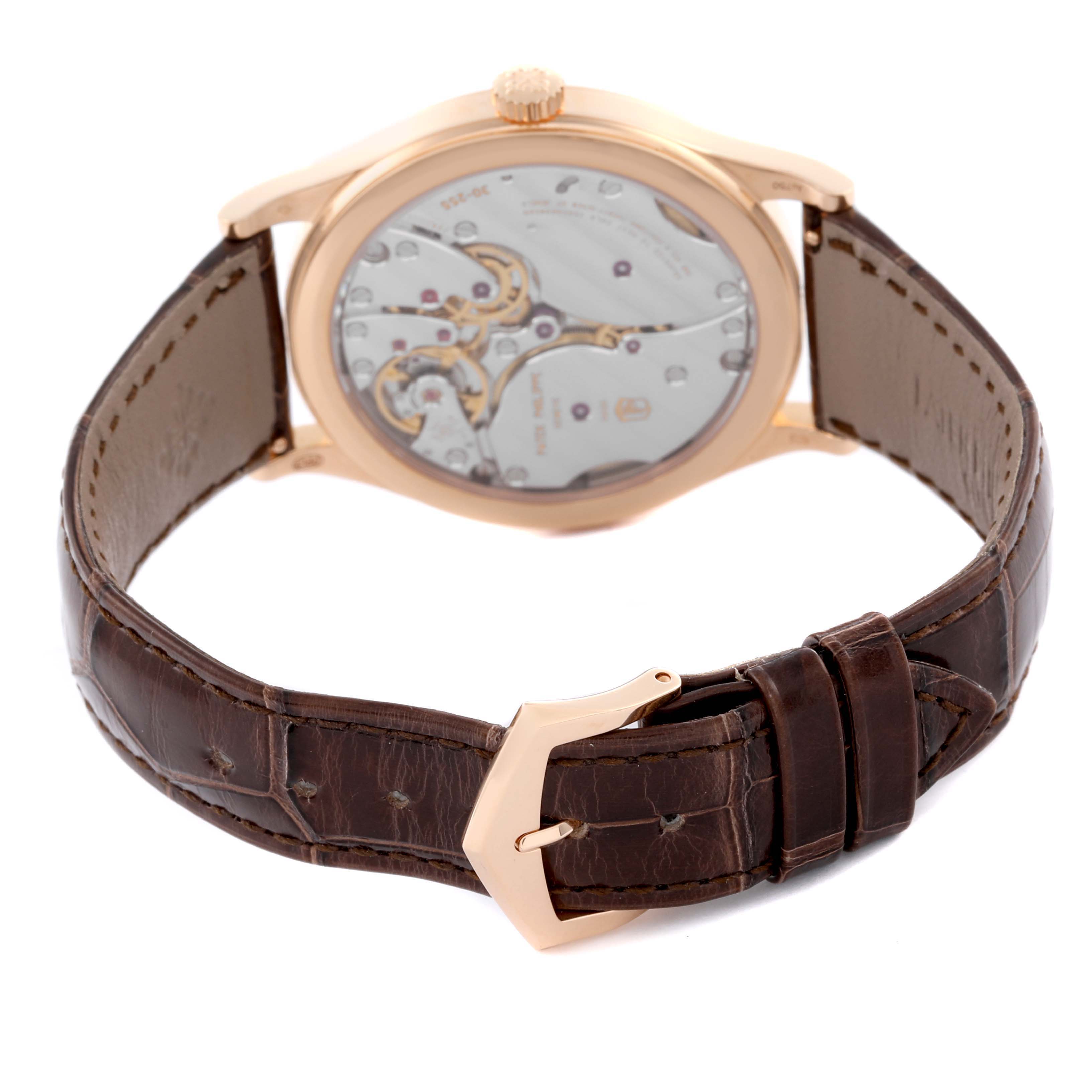 The image shows the back view of the Patek Philippe Calatrava 6119R-001 Men's Rose Gold Silver Dial 6119R-001 Men's Rose Gold Silver Dial watch with its movement visible and the brown leather strap.