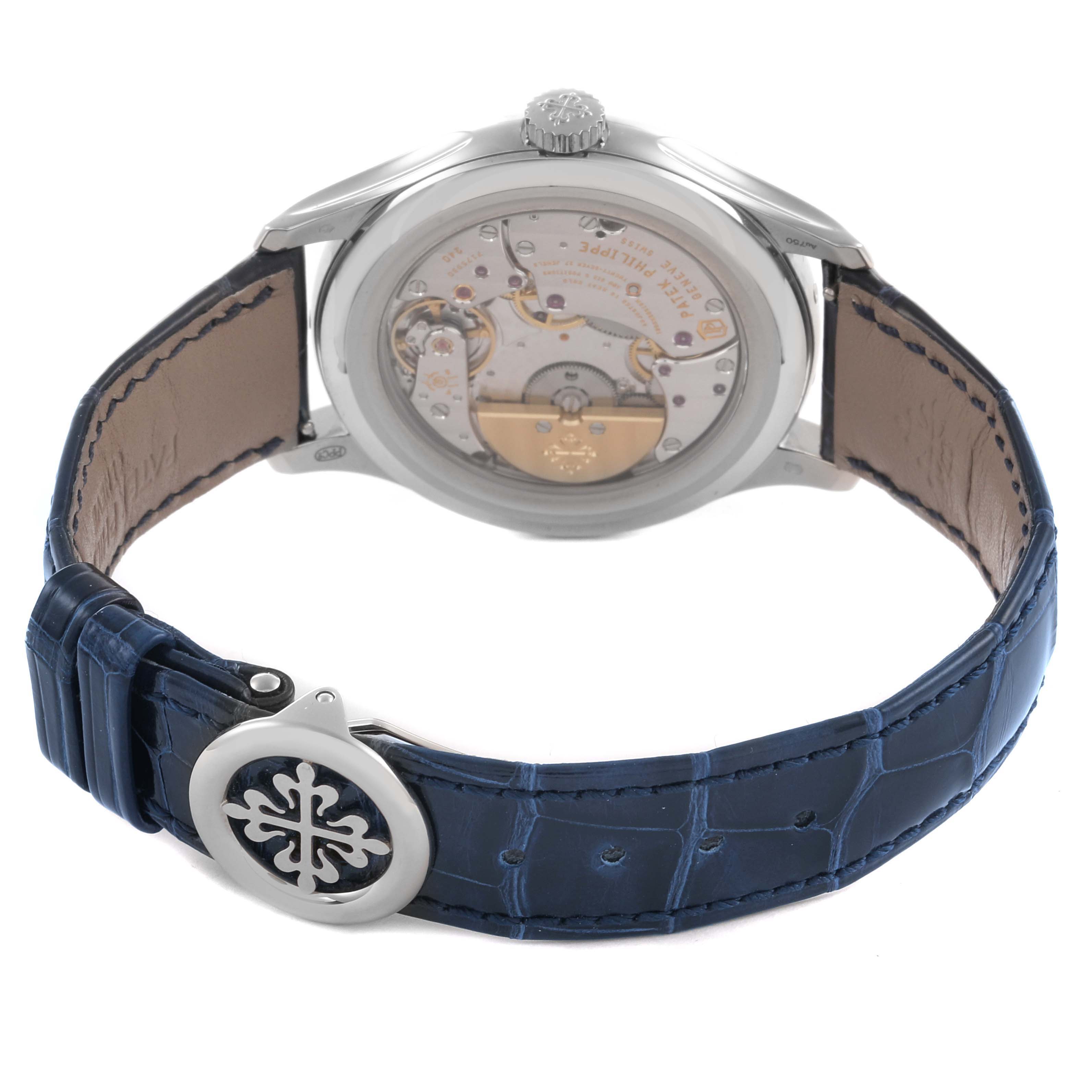 The image shows the back view of the Patek Philippe Complications 5327G-001 Men's White Gold Blue Dial 5327G-001 Men's White Gold Blue Dial watch, highlighting the movement and a blue leather strap.