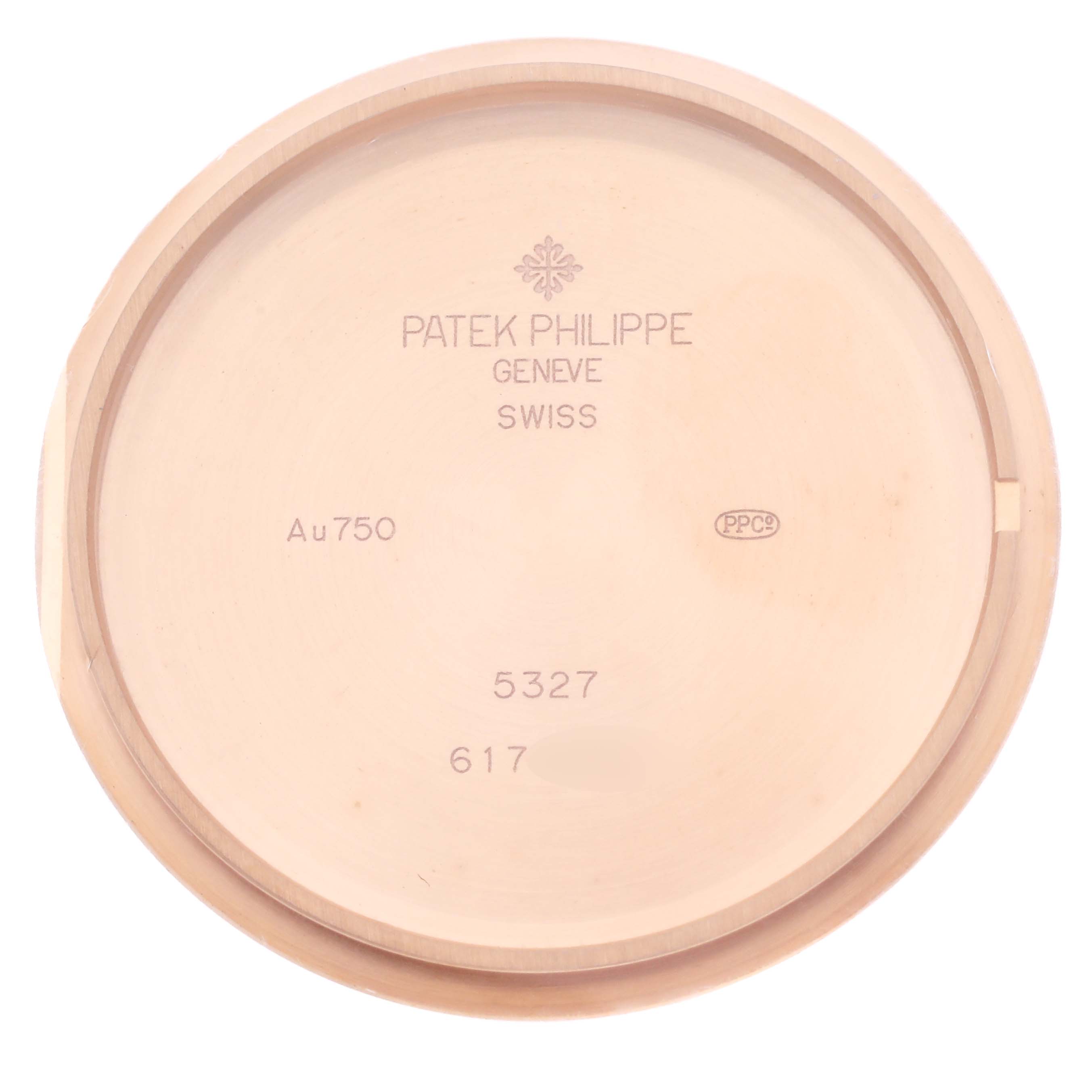 This image shows the back cover of a Patek Philippe Complications 5327R-001 Men's Rose Gold White Dial 5327R-001 Men's Rose Gold White Dial model, displaying inscriptions and hallmarks.