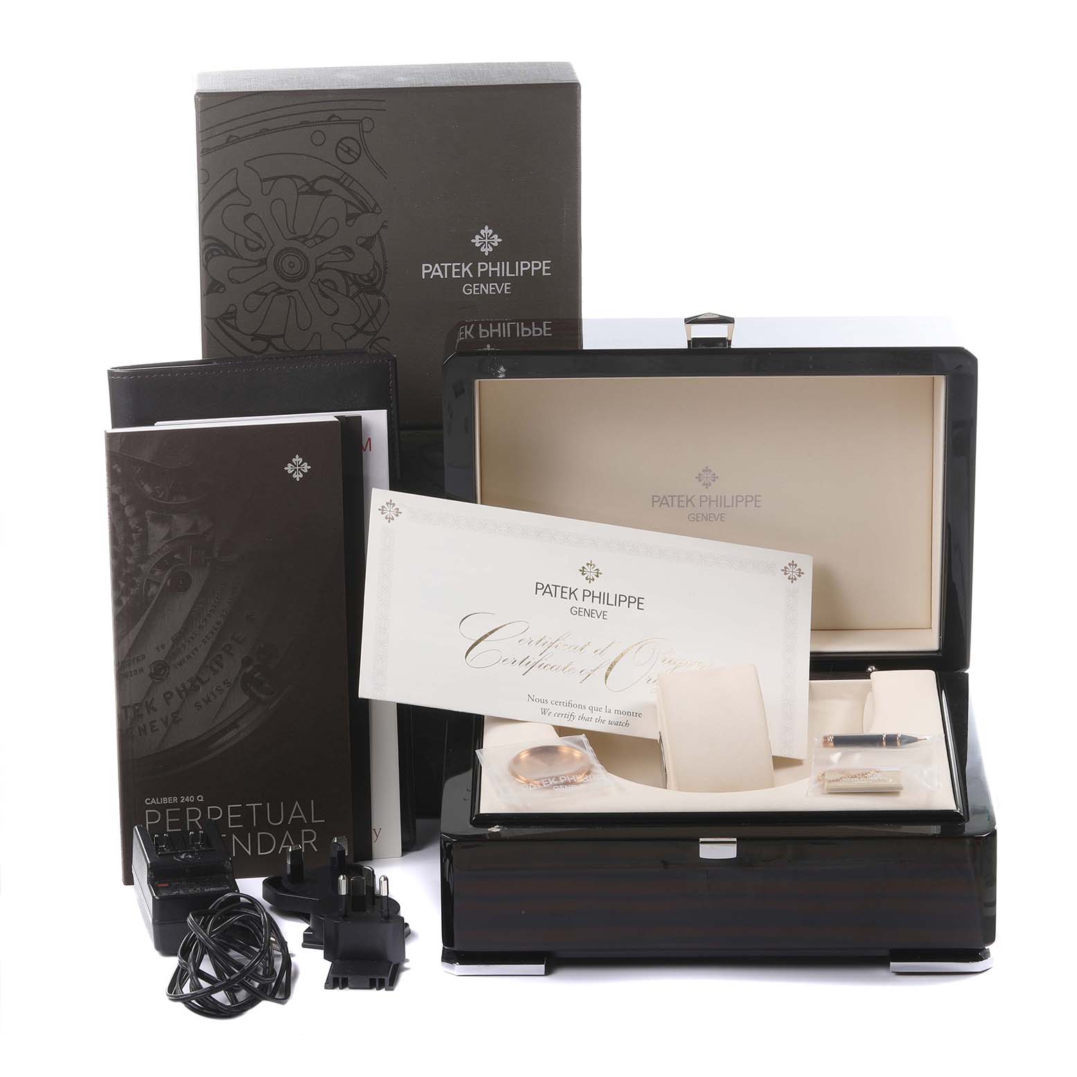 The image shows a Patek Philippe Complications 5327R-001 Men's Rose Gold White Dial 5327R-001 Men's Rose Gold White Dial box with manuals, a certificate, and accessories at a straight-on angle.