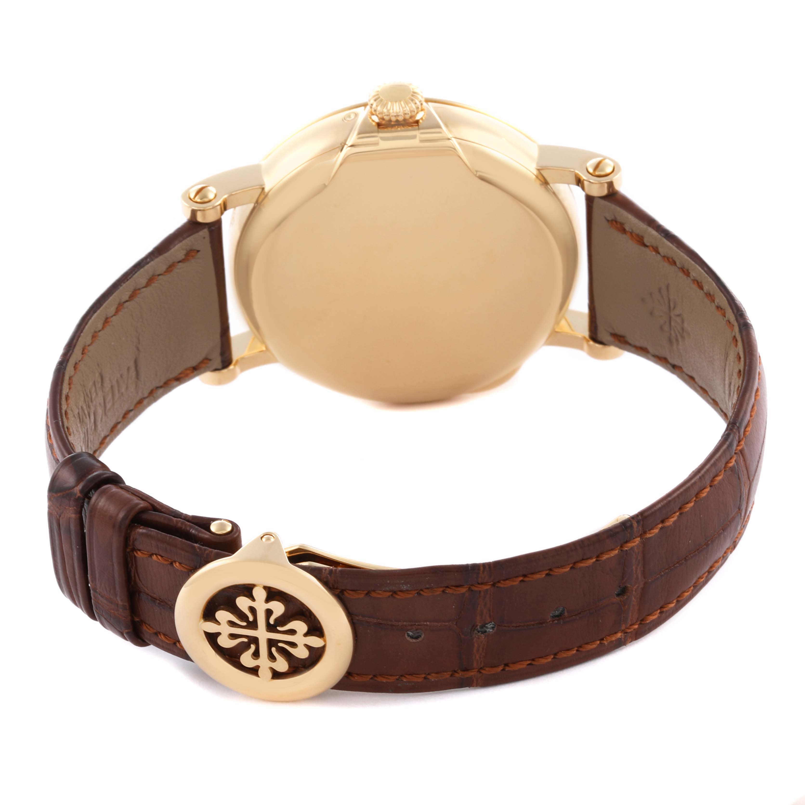The image shows the back case and clasp of a Patek Philippe Complications 5159J Men's Yellow Gold Silver Dial 5159J Men's Yellow Gold Silver Dial watch, with a visible leather strap.