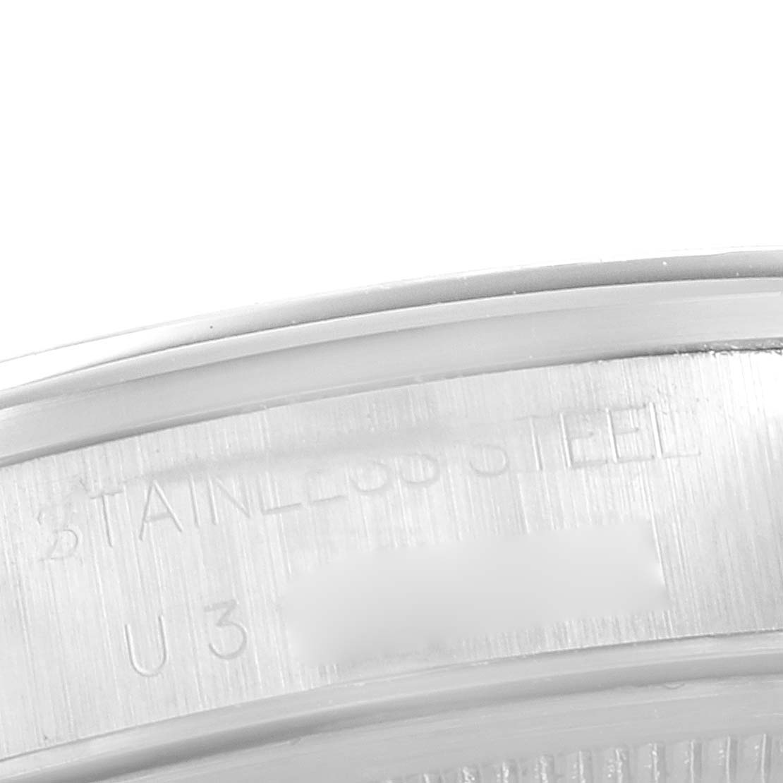 This image shows a close-up of the case back edge of a Rolex Air-King 14000 Men's Stainless Steel Blue Dial 14000 Men's Stainless Steel Blue Dial watch, highlighting the "stainless steel" engraving.