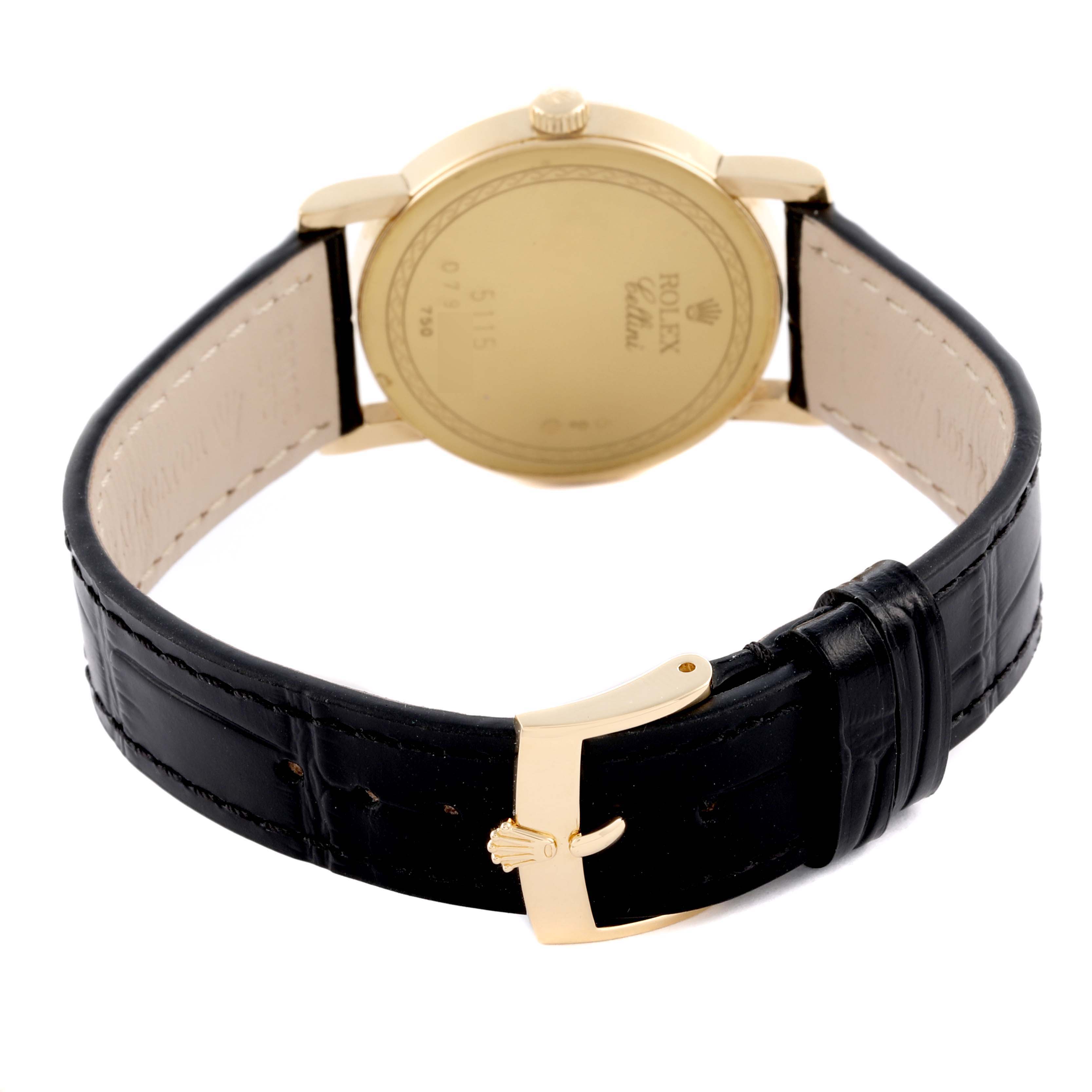 The image shows the back of a Rolex Cellini 5115 Men's Yellow Gold Silver Dial 5115 Men's Yellow Gold Silver Dial watch, featuring the gold case, black leather strap, and buckle.