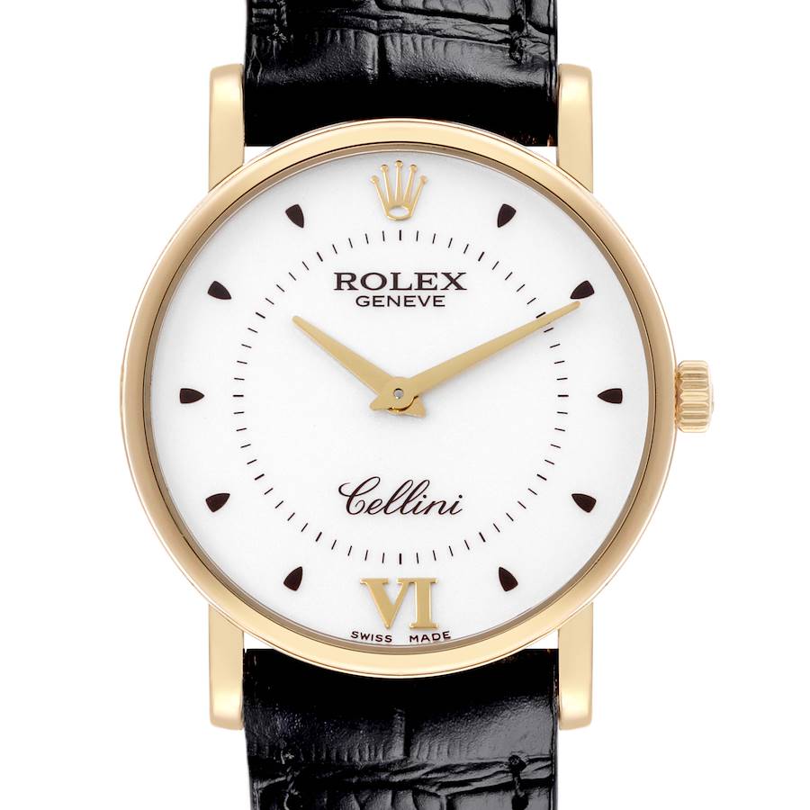 The image shows a Rolex Cellini watch from a frontal angle, highlighting its gold case, white dial, crown, and black leather strap.