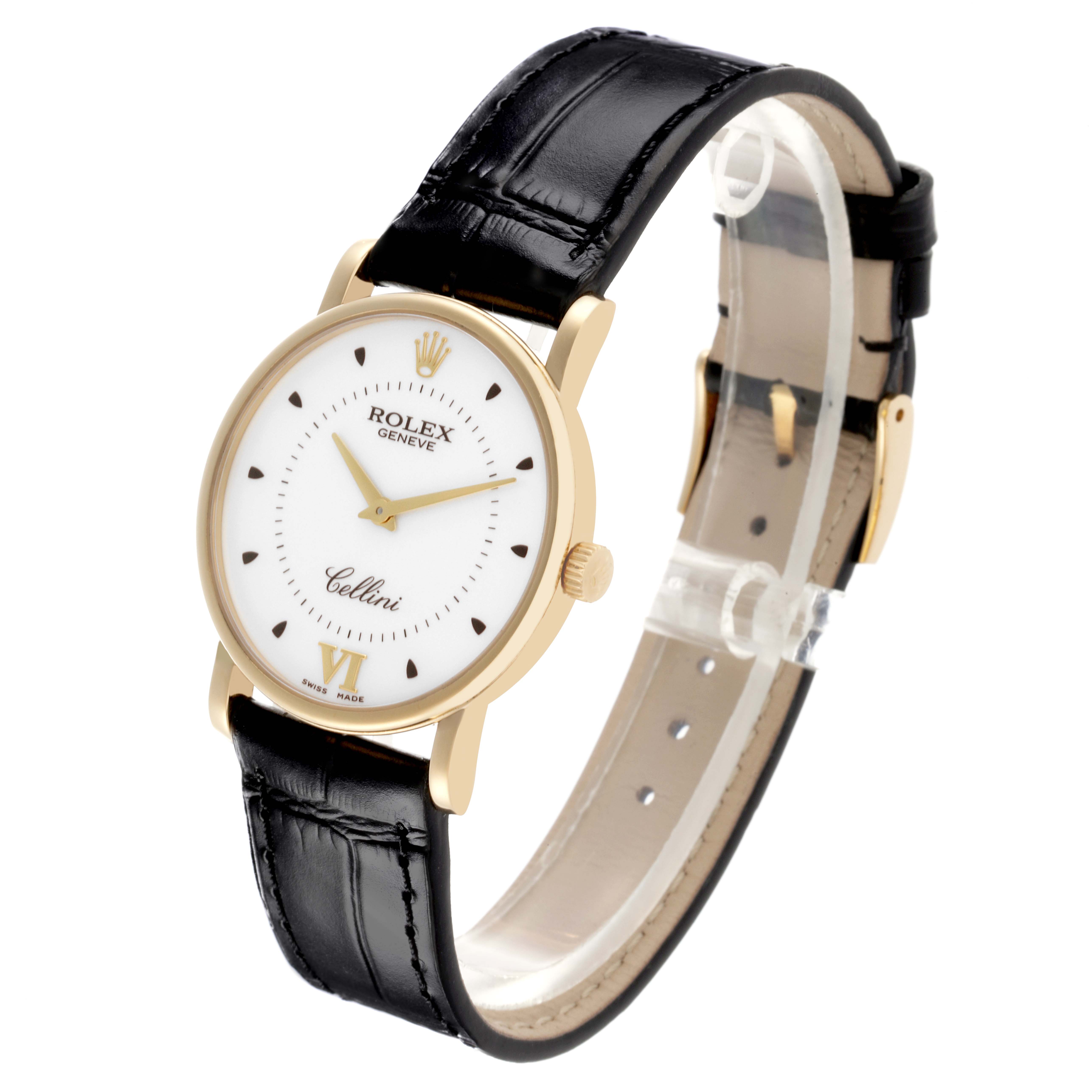 The Rolex Cellini 5115 Men's Yellow Gold Silver Dial 5115 Men's Yellow Gold Silver Dial watch is shown at an angle displaying the gold case, white dial, black leather strap, and side crown.