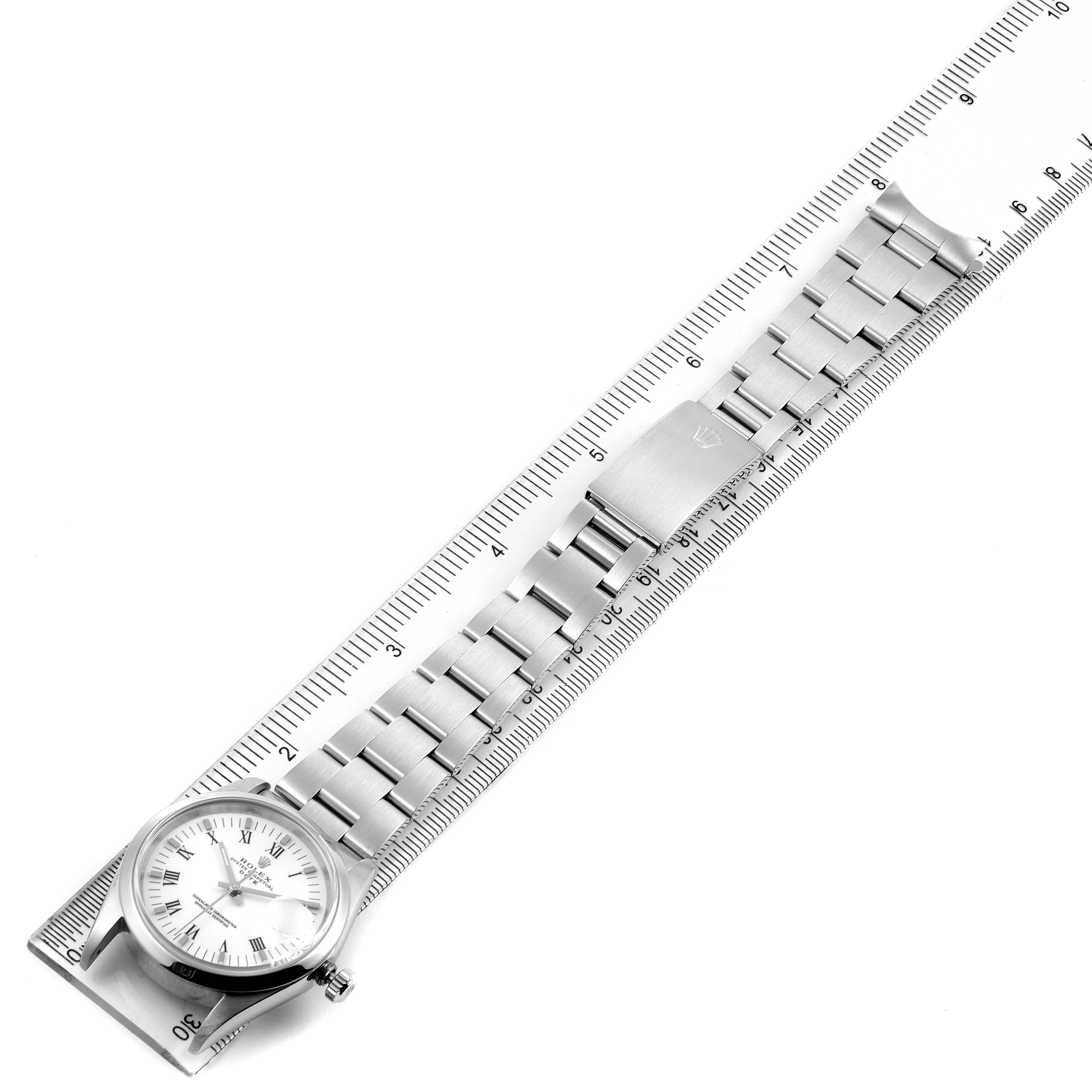 The image shows a top-down view of a Rolex Date 15200 Men's Stainless Steel White Dial 15200 Men's Stainless Steel White Dial model watch laid flat beside a ruler, displaying its face, bracelet, and clasp.