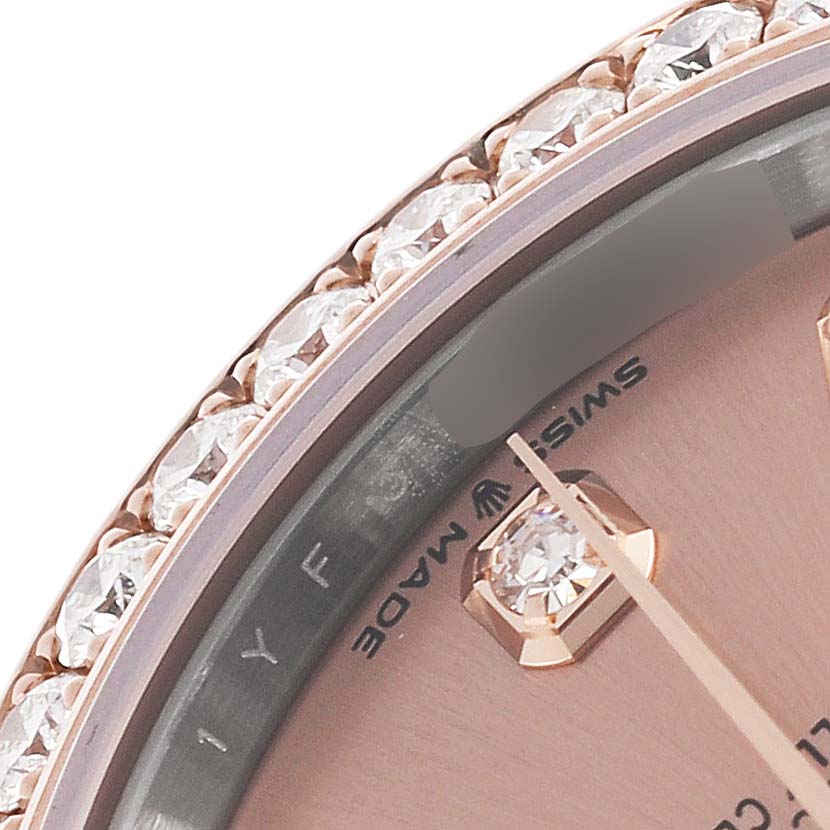 The image shows a close-up of the dial and diamond-set bezel of a mid-size Rolex watch.