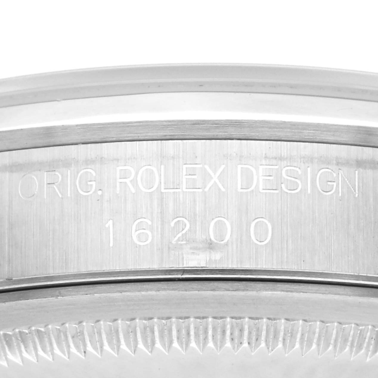 The image shows a close-up of the side view of a Rolex Datejust 16200 Men's Stainless Steel Silver Dial 16200 Men's Stainless Steel Silver Dial model, focusing on the engraved case back.