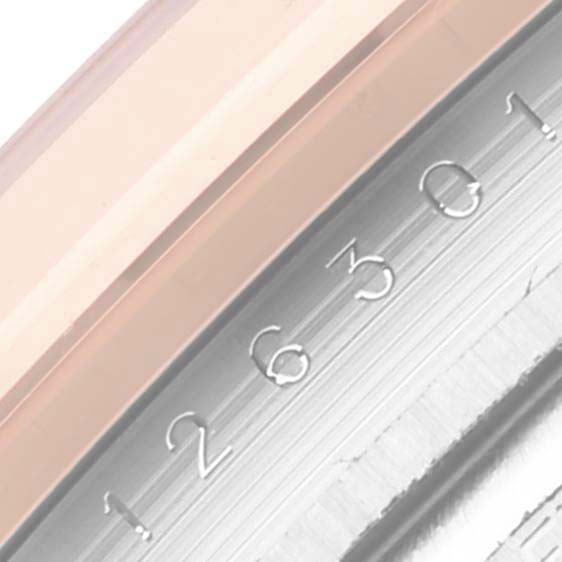 The image shows a close-up of the bezel and engraved serial numbers on the side of the Rolex Datejust 41 126301 Men's Steel and Gold (two tone) Pink Dial 126301 Men's Steel and Gold (two tone) Pink Dial.