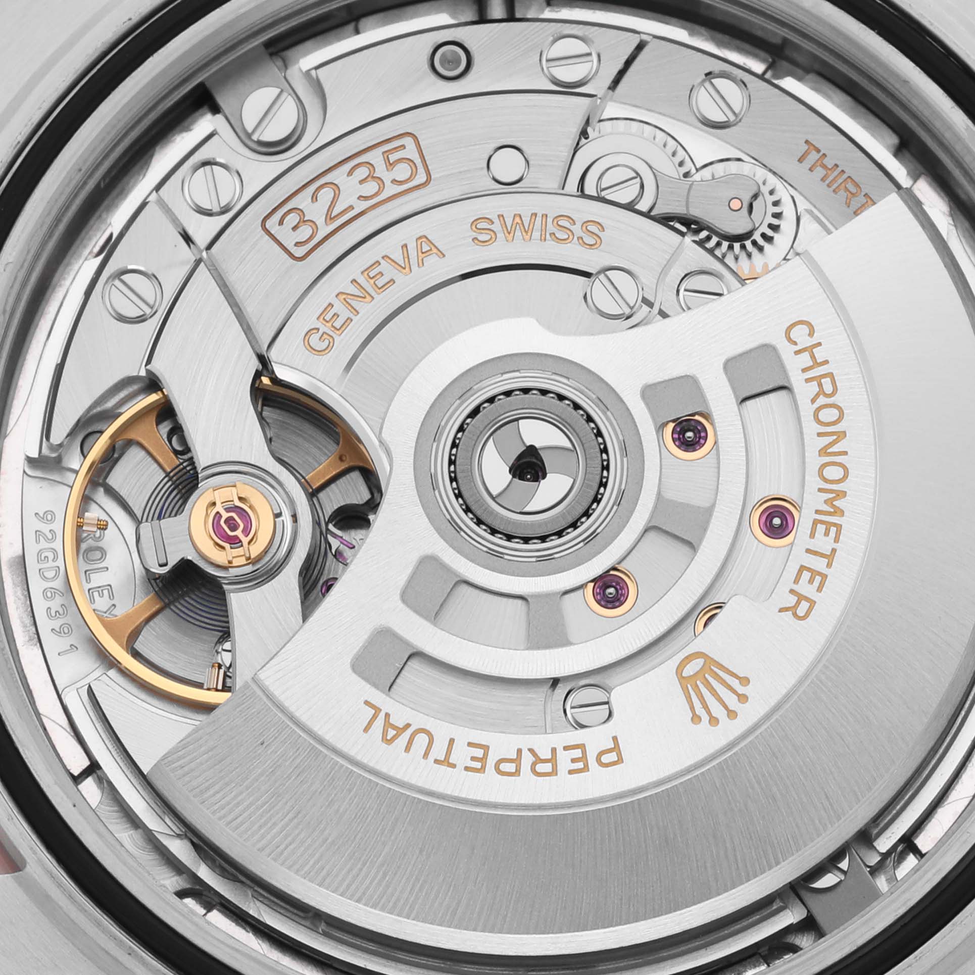 The image shows a close-up of the Rolex Datejust 41 126301 Men's Steel and Gold (two tone) Pink Dial 126301 Men's Steel and Gold (two tone) Pink Dial's movement, highlighting the caliber 3235 with intricate detailing.