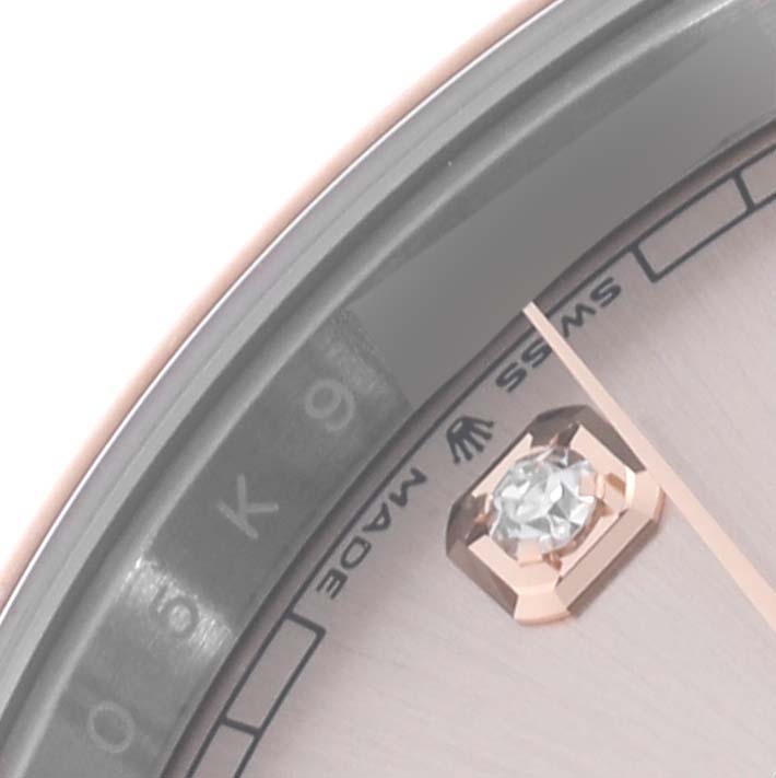 The image shows a close-up of the dial and bezel of a Rolex Datejust 41 126301 Men's Steel and Gold (two tone) Pink Dial 126301 Men's Steel and Gold (two tone) Pink Dial, showcasing an index marker and part of the engraving.