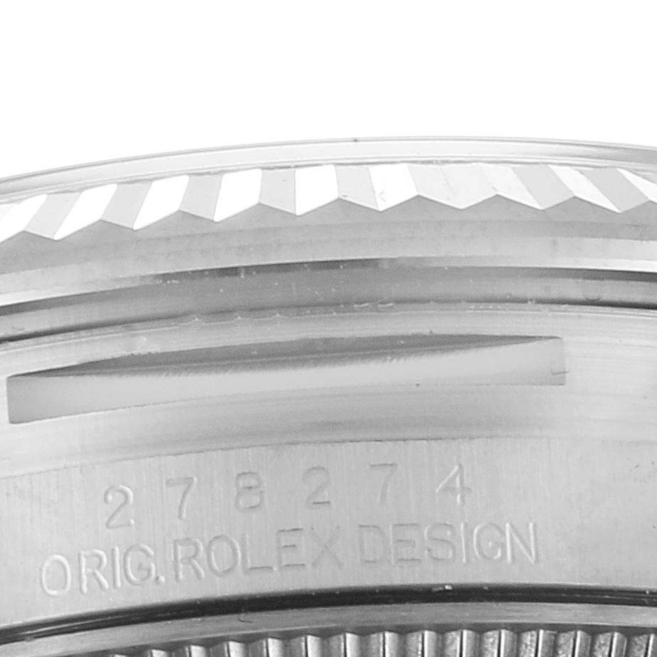 This image shows a close-up of the side of a Rolex Mid-Size 278274 Women
s Stainless Steel Blue Dial 278274 Women
s Stainless Steel Blue Dial watch, highlighting the engraved bezel and the "ORIG. ROLEX DESIGN" text.