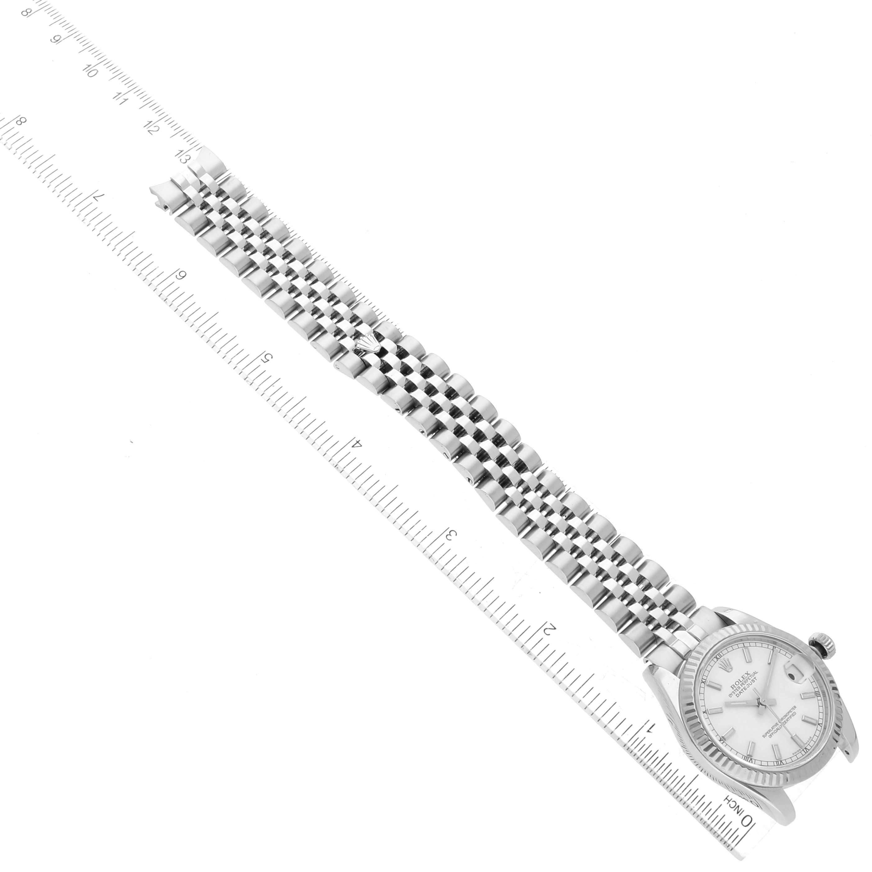 The image shows the top view of a Mid-Size Rolex watch, displaying the face, case, and full length of the band against a ruler.