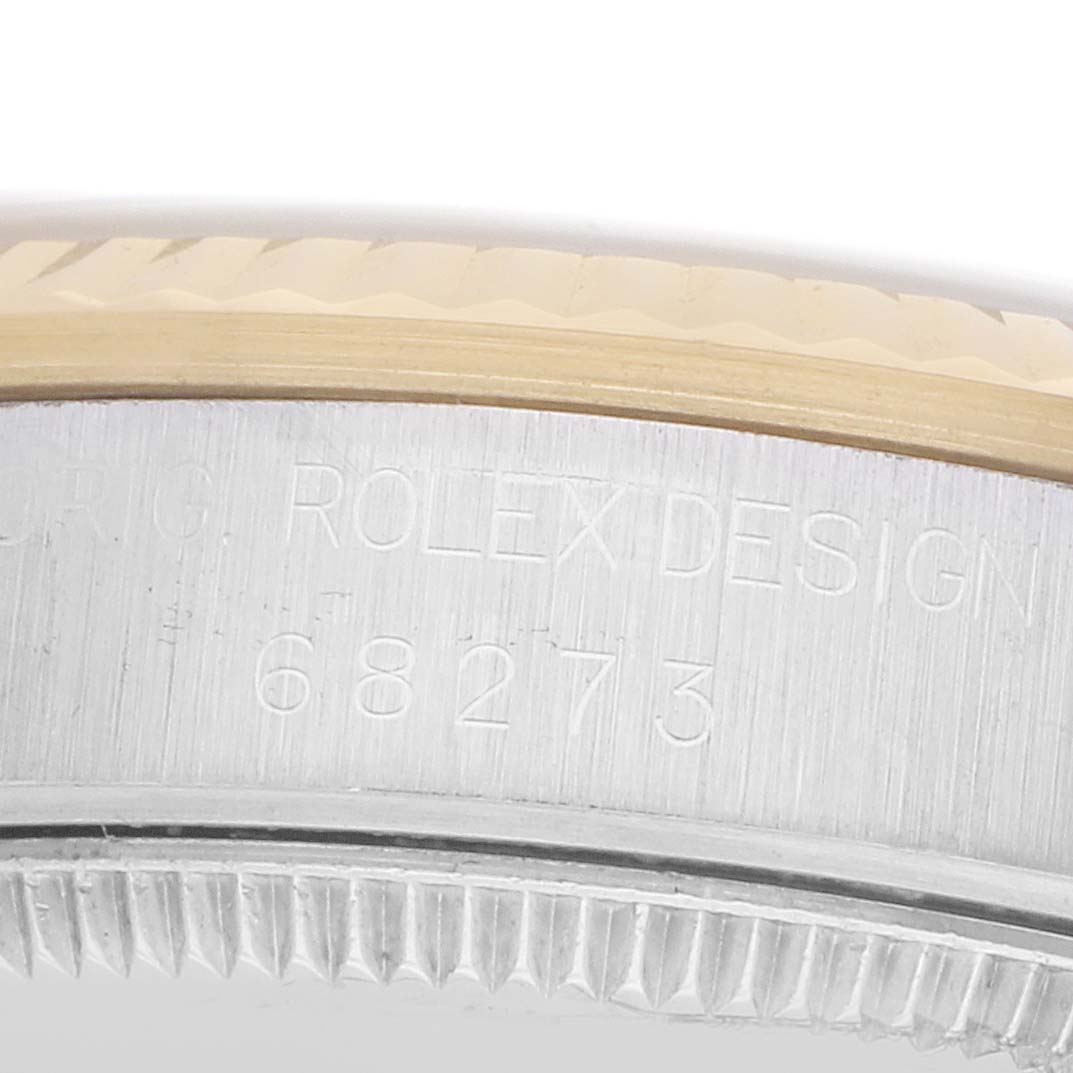 The image shows a close-up of the side of a Rolex Mid-Size 68273 Women's Steel and Gold (two tone) Blue Dial watch, highlighting the engraved model number "68273."