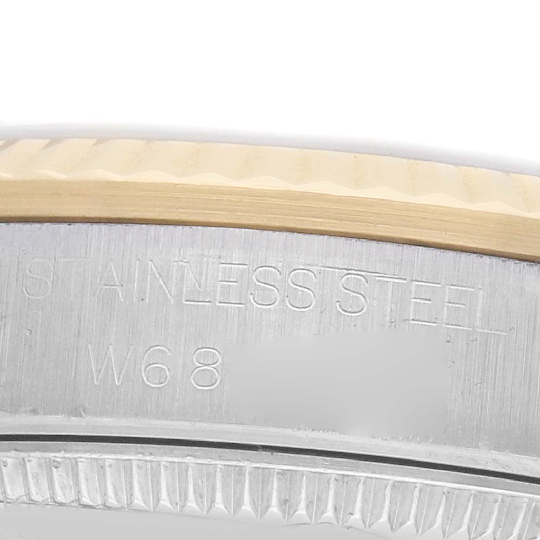 The image shows a close-up of the stainless steel bezel and edge of the case back of a Rolex Mid-Size 68273 Women's Steel and Gold (two tone) Blue Dial watch.
