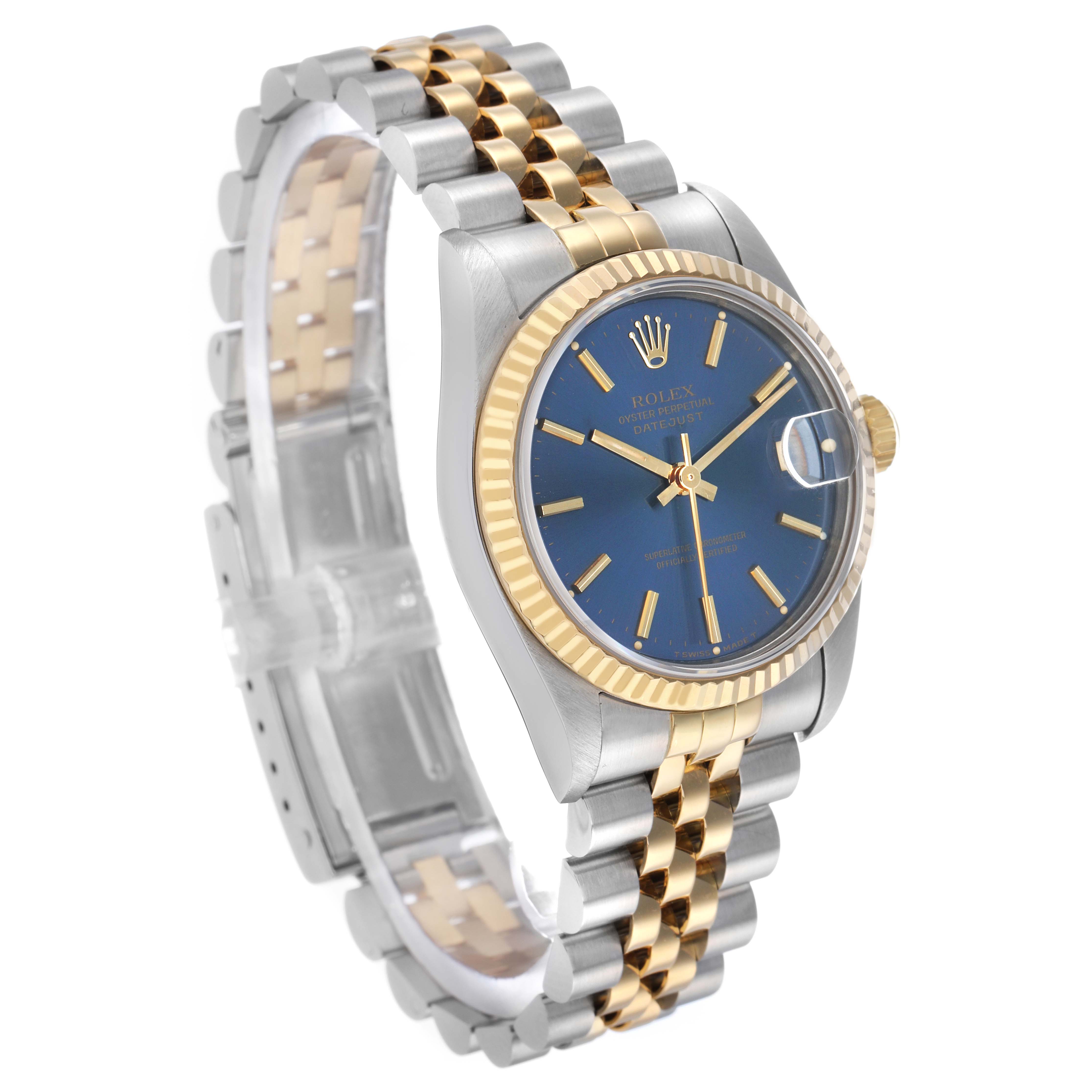 The Rolex Mid-Size 68273 Women's Steel and Gold (two tone) Blue Dial watch is shown from an angled side view, highlighting the blue dial, gold bezel, and two-tone bracelet.