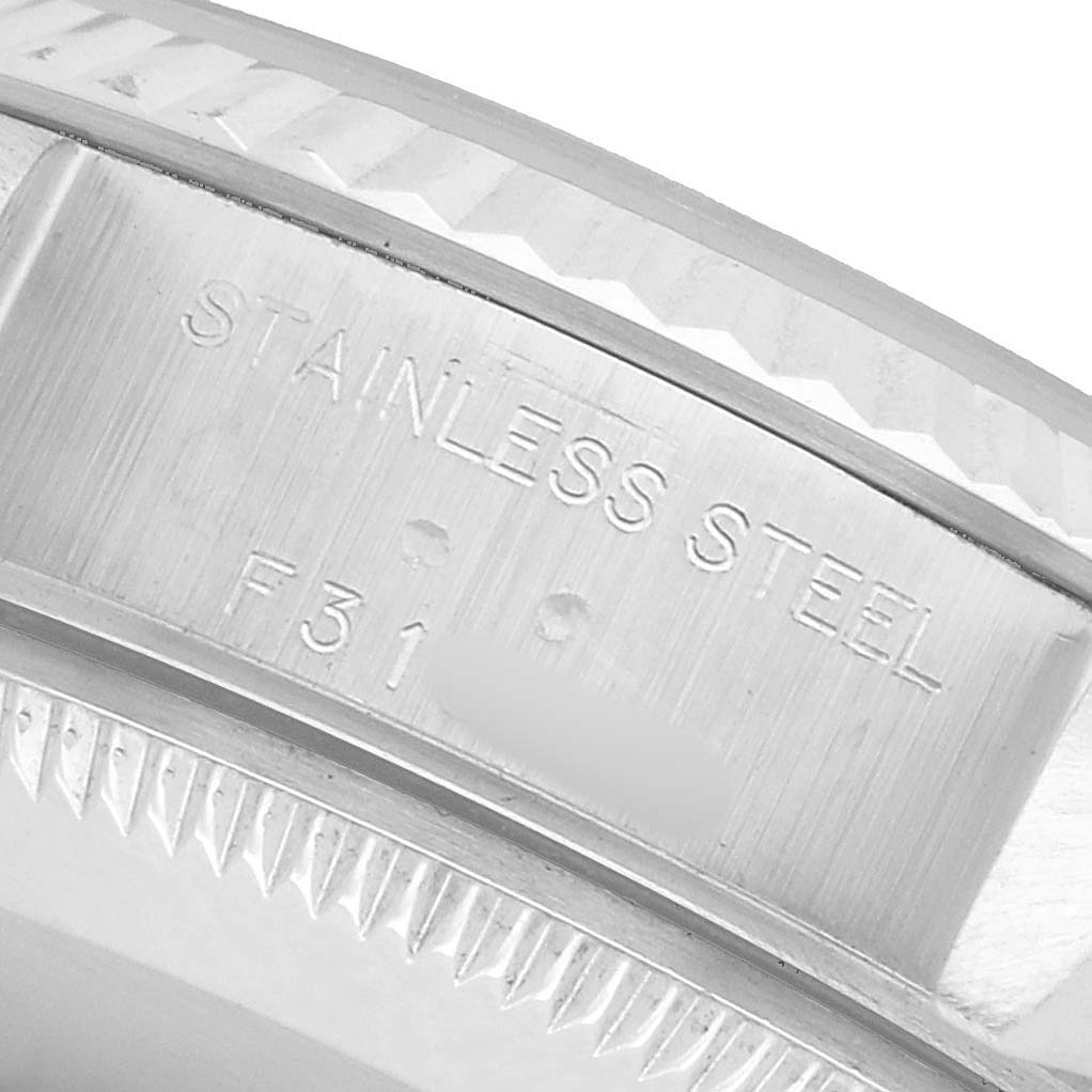 The image shows a close-up of the side of a Rolex Datejust 79174 Women's Stainless Steel Pink Dial watch, highlighting the stainless steel engravings on the case.