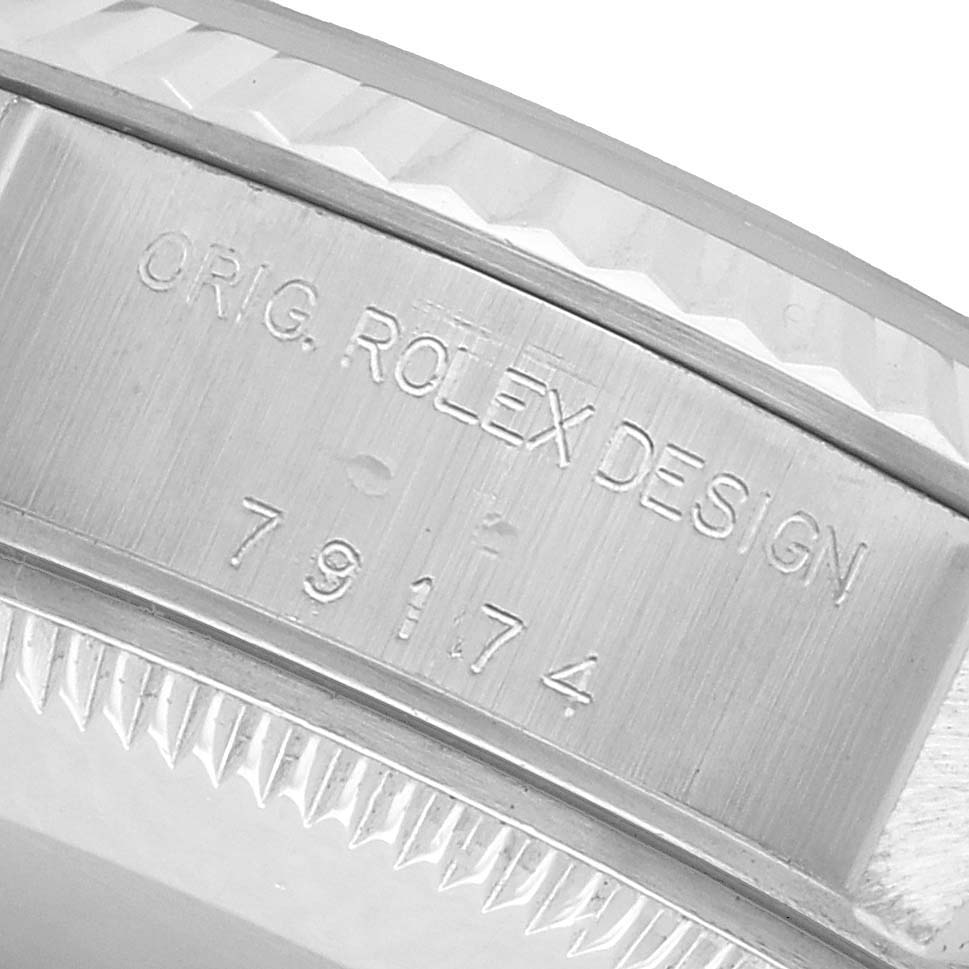 The image shows a close-up of the side engraving on the case of a Rolex Datejust 79174 Women's Stainless Steel Pink Dial, featuring the model number and "Orig. Rolex Design."