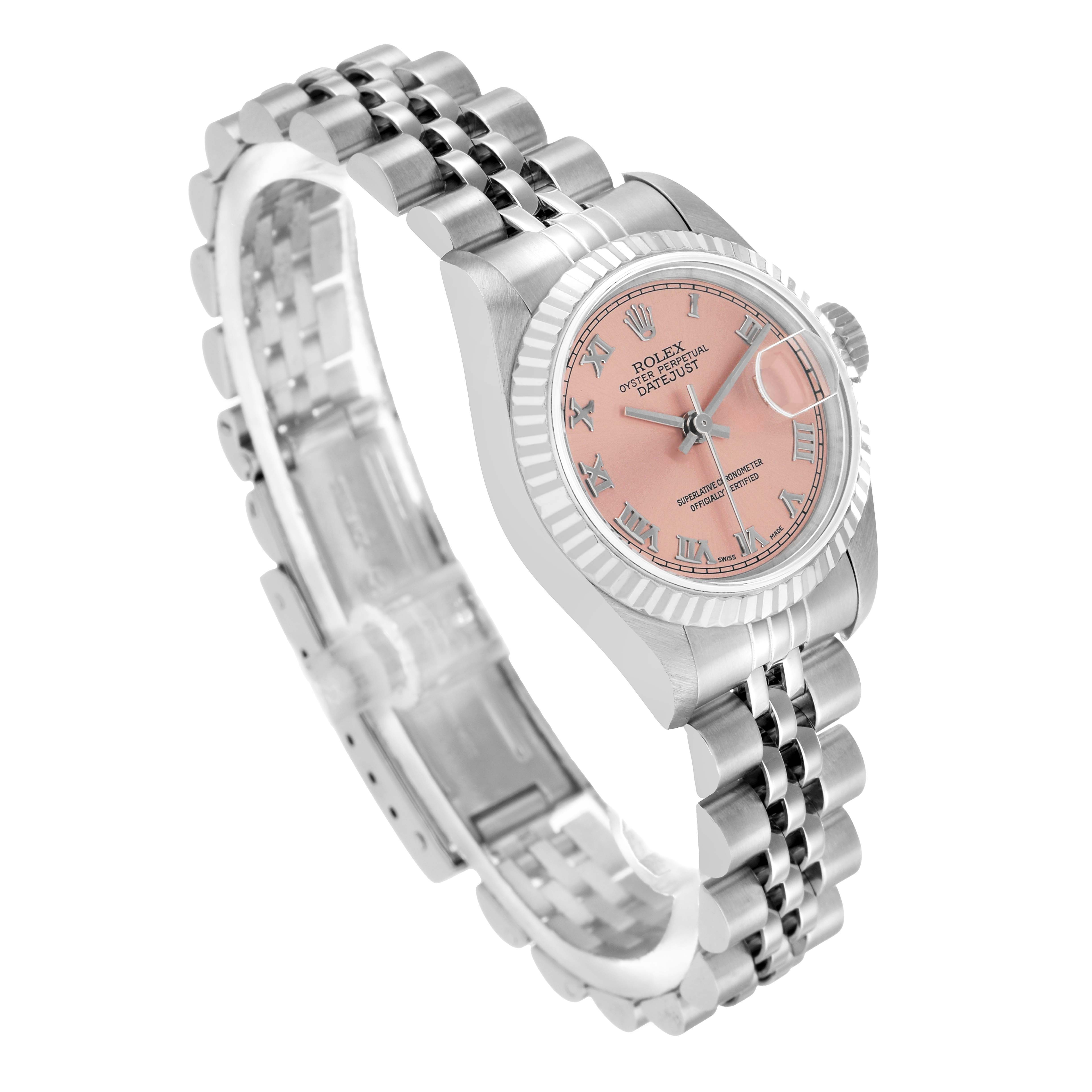 The Rolex Datejust 79174 Women's Stainless Steel Pink Dial watch is shown at an angled side view, highlighting the pink dial, fluted bezel, and Jubilee bracelet.