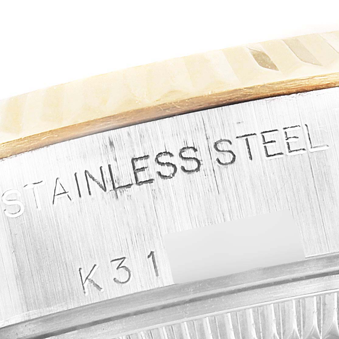 This image shows a close-up of the stainless steel part of a Rolex Datejust 79173 Women
s Steel and Gold (two tone) Champagne Dial 79173 Women
s Steel and Gold (two tone) Champagne Dial watch, including the engraving.