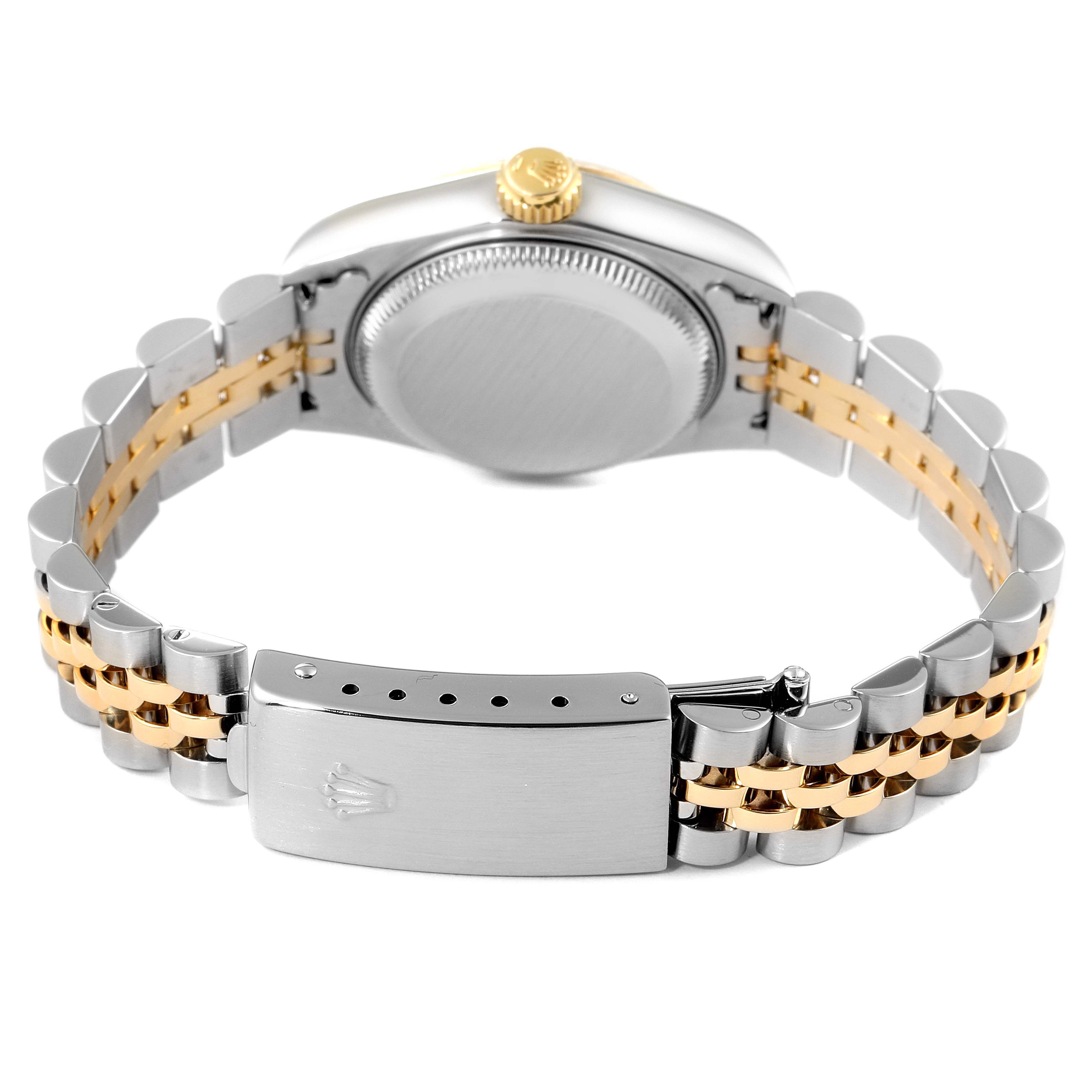 The image shows the back view of a Rolex Datejust 79173 Women
s Steel and Gold (two tone) Champagne Dial 79173 Women
s Steel and Gold (two tone) Champagne Dial watch, including the caseback, crown, and two-tone bracelet with a closed clasp.