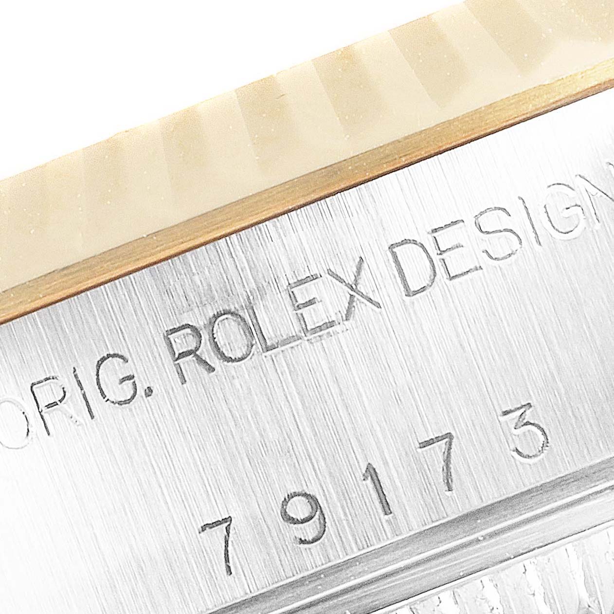 The image shows a close-up of the engraved serial number on a Rolex Datejust 79173 Women
s Steel and Gold (two tone) Champagne Dial 79173 Women
s Steel and Gold (two tone) Champagne Dial model watch bezel.