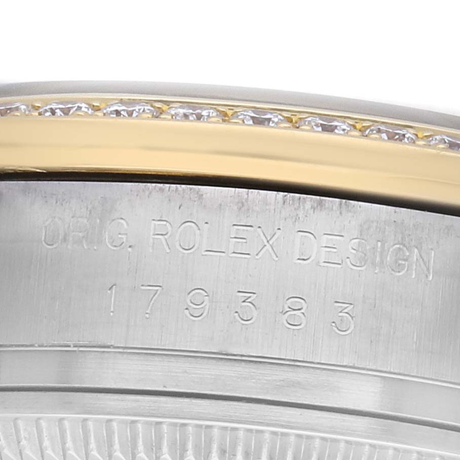 The image shows the side of a Rolex Datejust 179383 Women's Stainless Steel Champagne Dial's case with engraved text and a diamond-studded bezel.