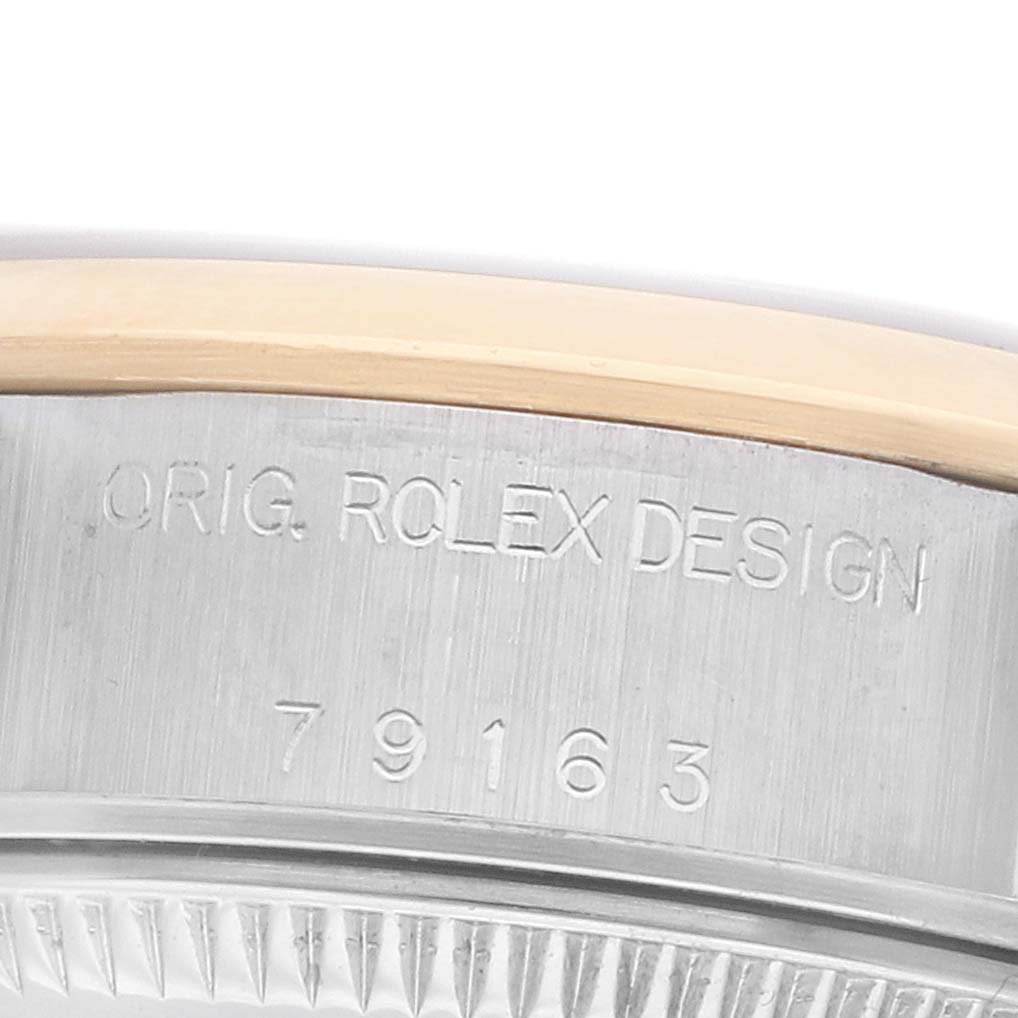 The image shows a close-up angle of the Rolex Datejust 79163 Women's Steel and Gold (two tone) Beige Dial model's side, highlighting the engraved "ORIG. ROLEX DESIGN" and serial number.