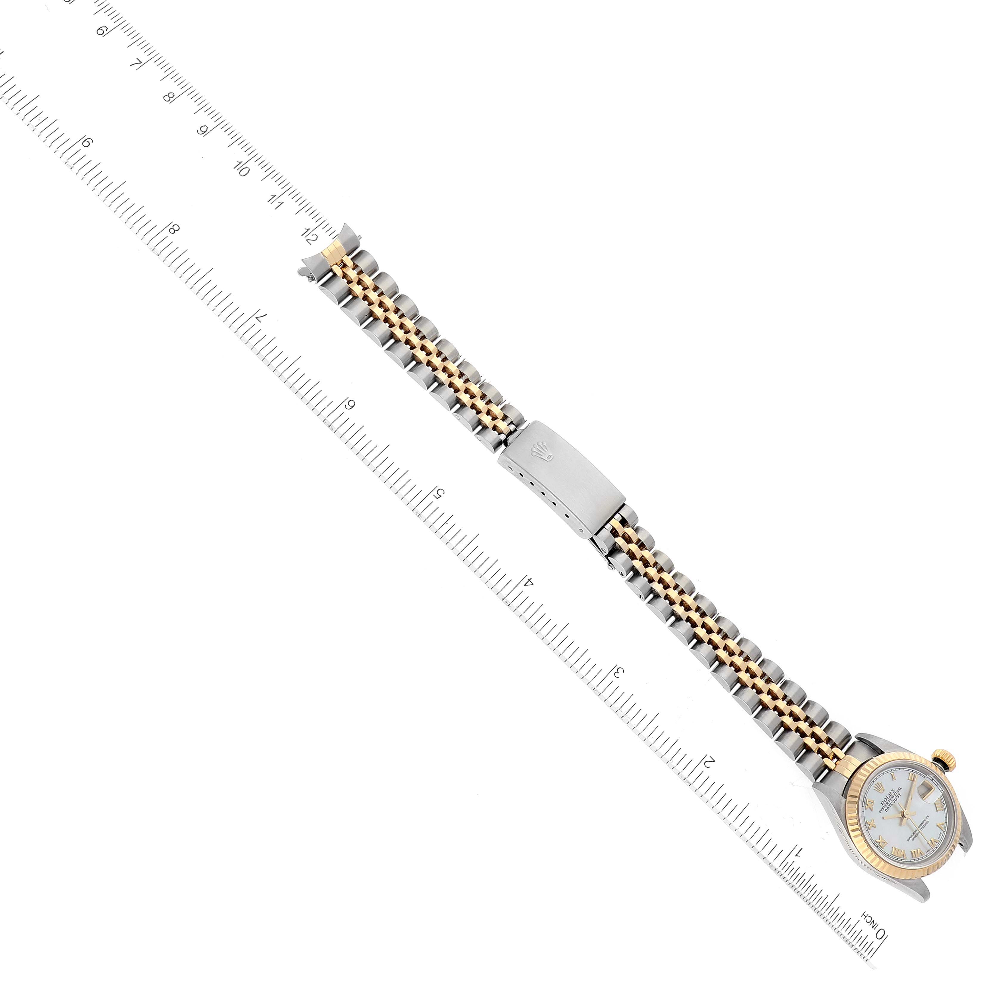 This image shows a Rolex Datejust 79173 Women's Steel and Gold (two tone) Mother of Pearl Dial 79173 Women's Steel and Gold (two tone) Mother of Pearl Dial watch from an above angle, prominently featuring the bracelet and clasp next to a ruler for scale.