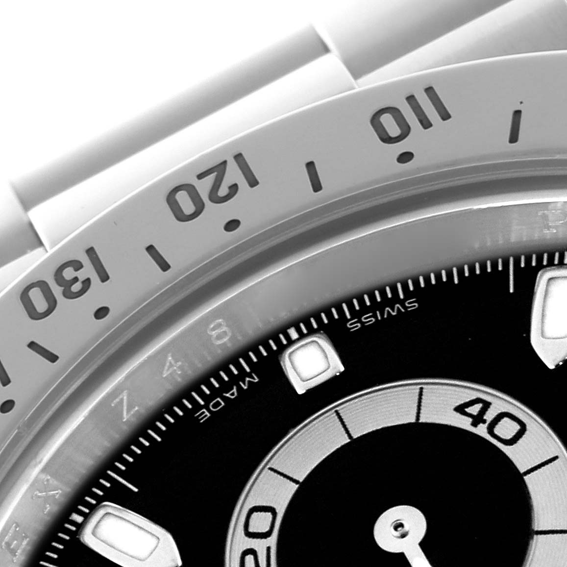 The image shows a close-up of the bezel and part of the dial of a Rolex Daytona 116520 Men
s Stainless Steel Black Dial 116520 Men
s Stainless Steel Black Dial watch, displaying numbers and indices.
