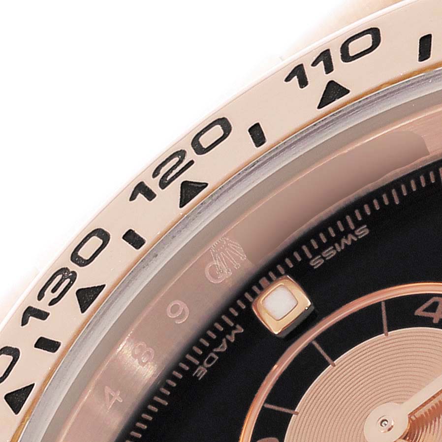 The image shows a close-up of the Rolex Daytona 116505 Men
s Rose Gold Black Dial 116505 Men
s Rose Gold Black Dial
s bezel and part of the dial.