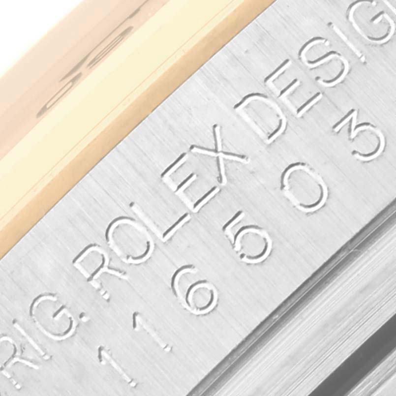 The image shows a close-up of the engraved side of a Rolex Daytona 116503-0004 Men's Steel and Gold (two tone) Black Dial 116503-0004 Men's Steel and Gold (two tone) Black Dial watch case, highlighting the "ROLEX DESIGN" text and serial number.